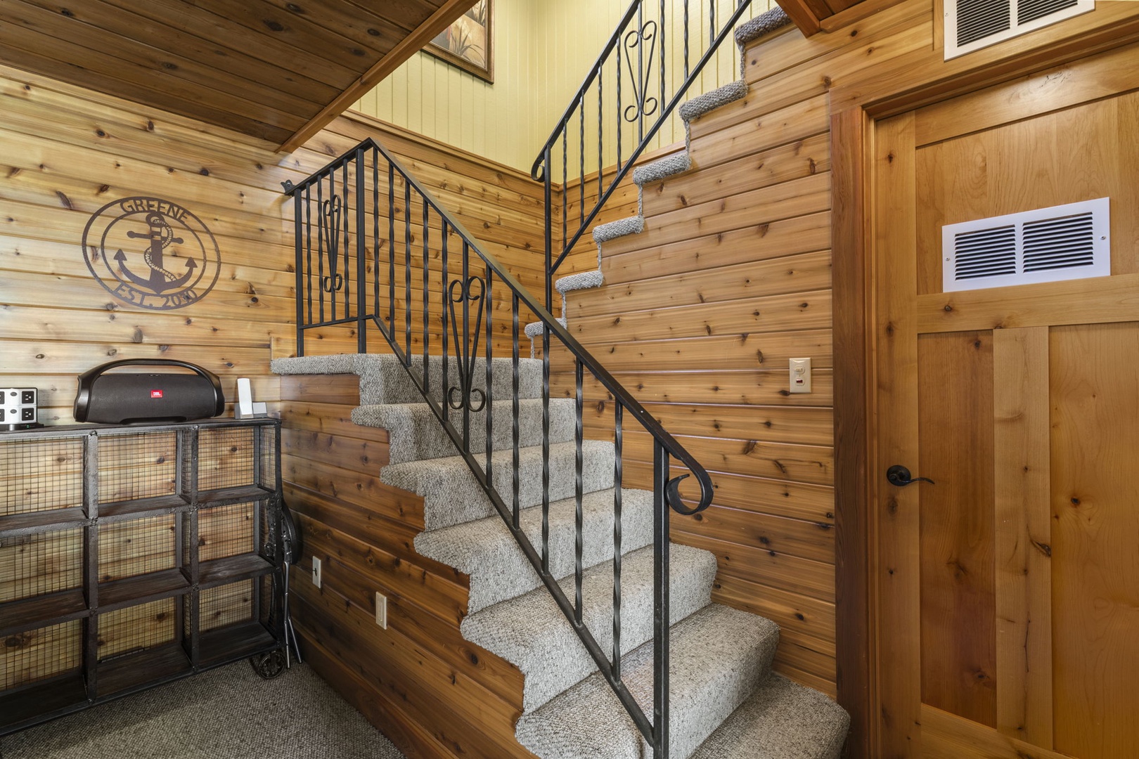 The carpeted staircase leads you upward through warm wood-paneled walls, bringing you closer to your private retreat. Cozy touches throughout set the tone for your mountain escape.