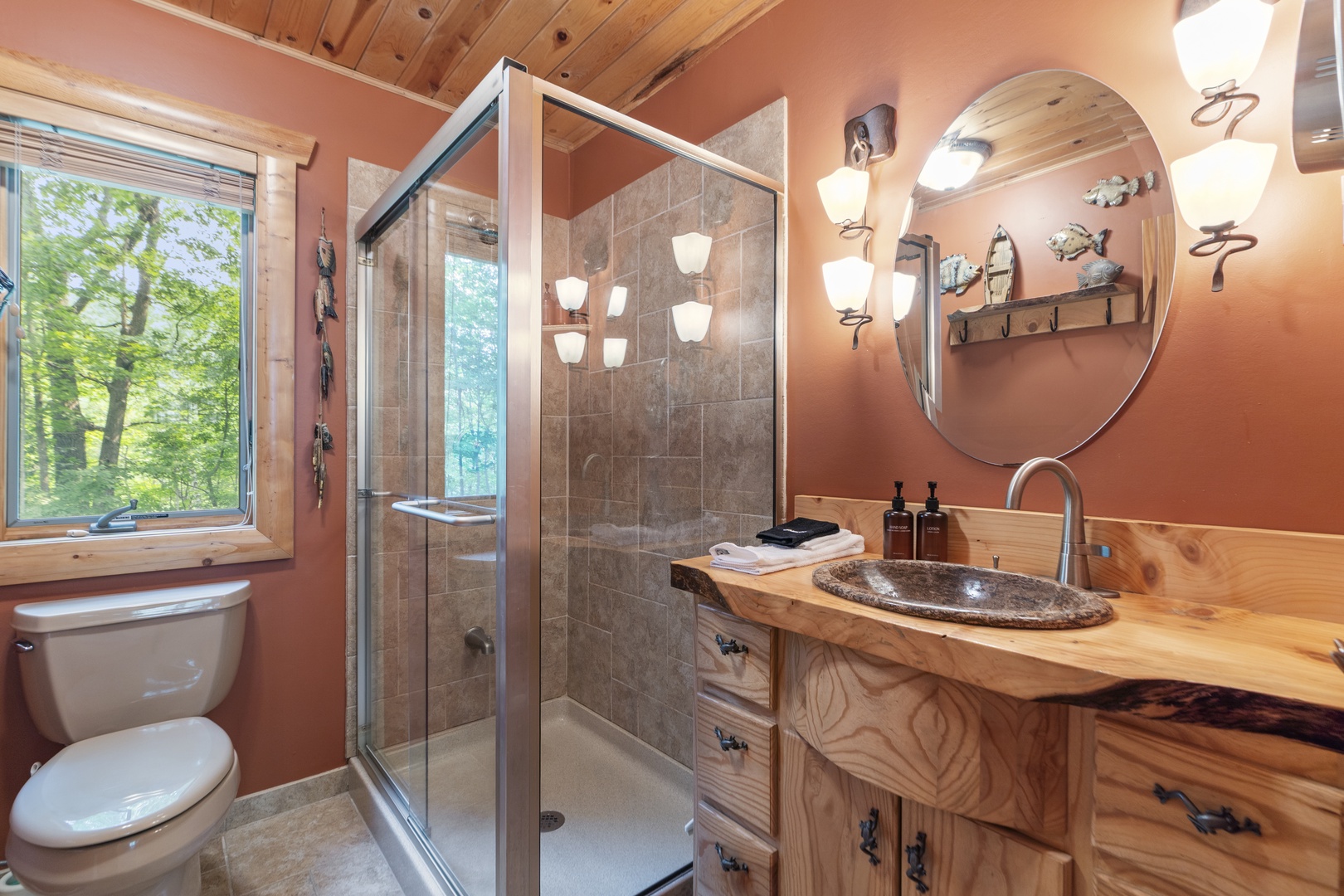 Step into your private sanctuary, where warm rustic tones meet modern comfort. Natural light streams through the window, illuminating handcrafted wood details and a spa-like shower—your perfect retreat after a day of adventure.
