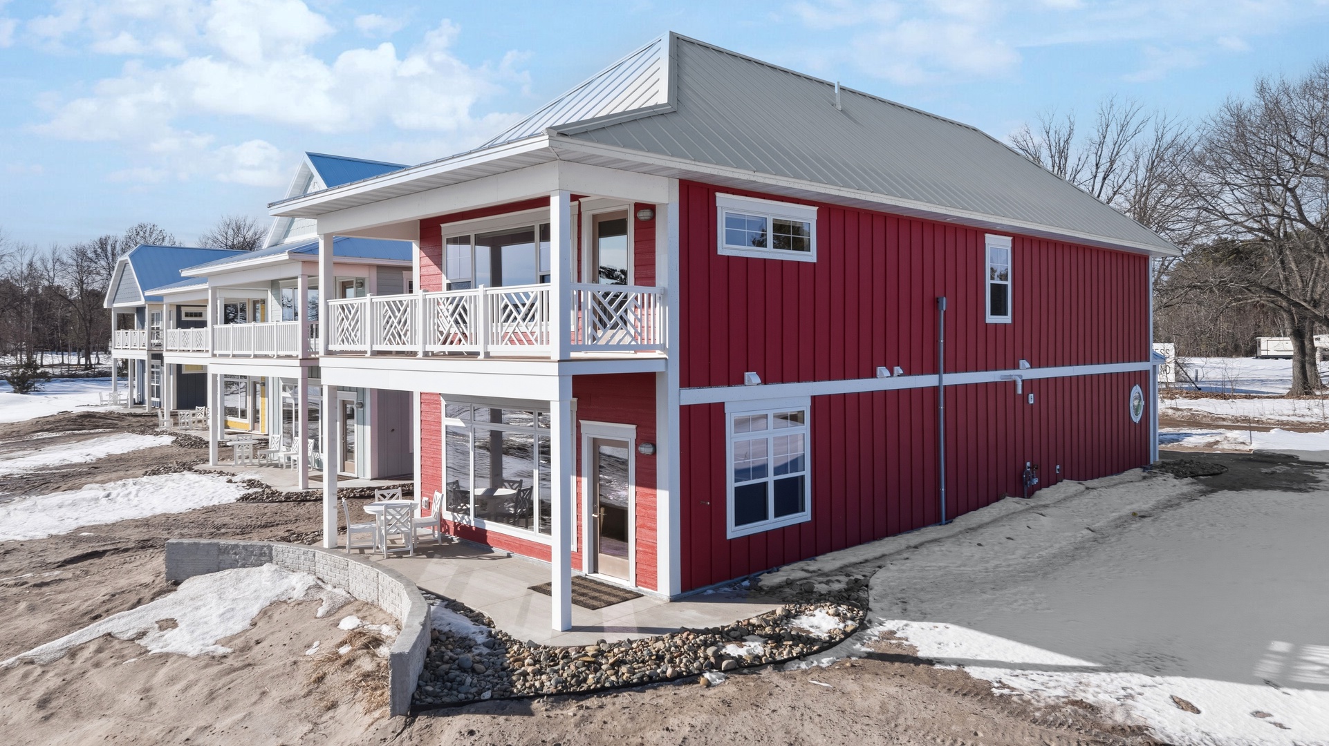 Red house back view with balcony porch and metal roof