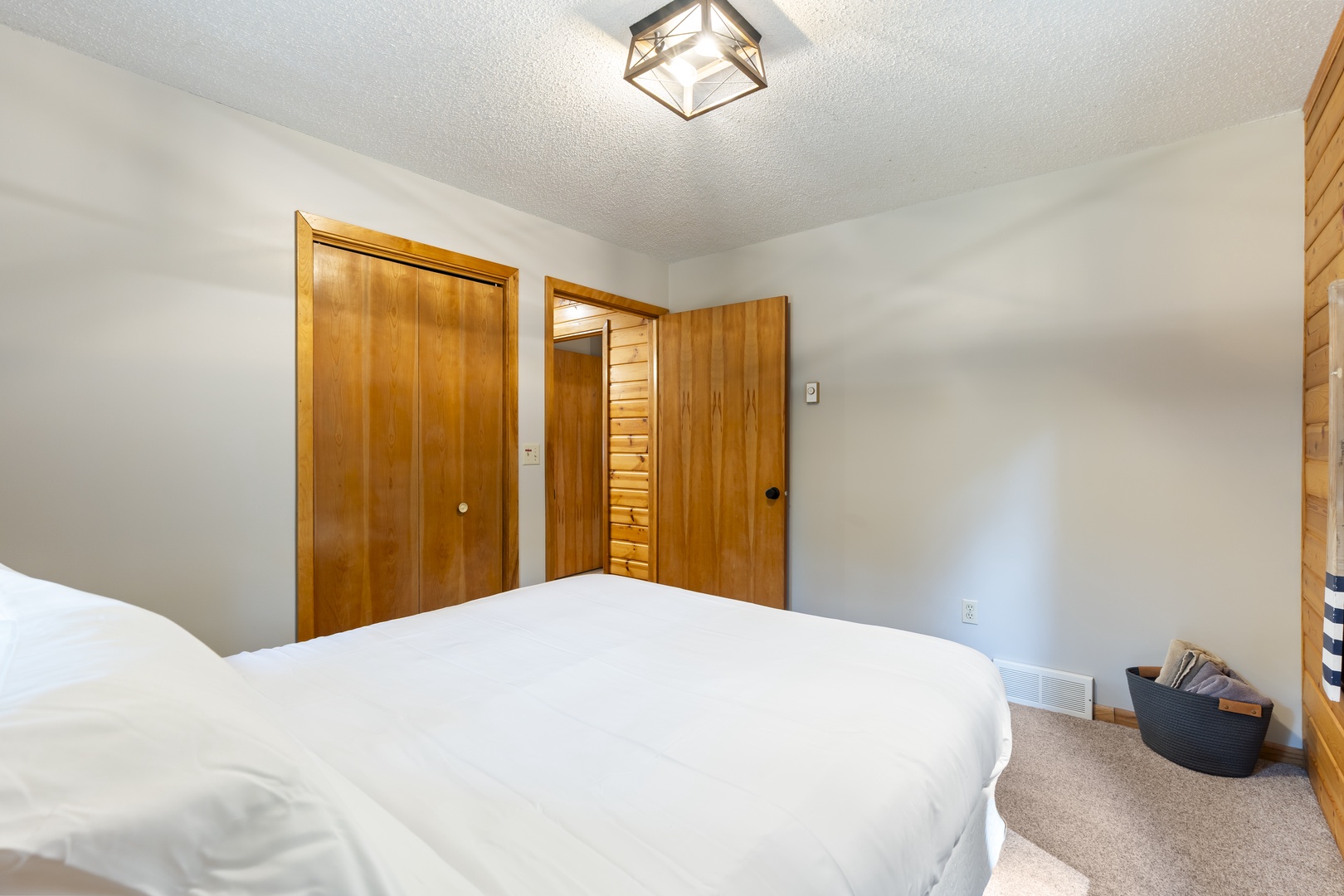 Unwind in your serene bedroom with crisp white linens, warm wood accents, and ample closet space for all your belongings.