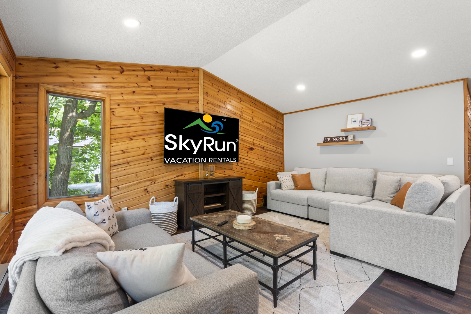 A light-filled living room with plush seating for the whole group, warm wood accents, and a big-screen TV for movie nights.