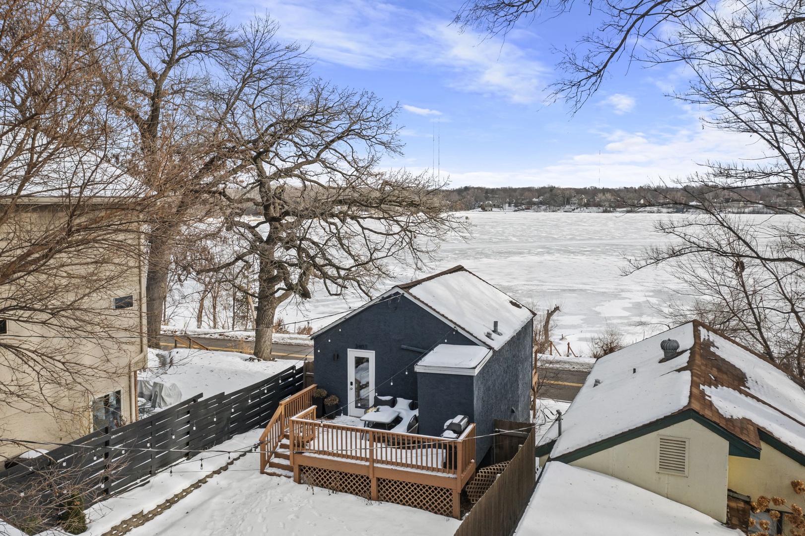 Lakefront property with snow-covered deck overlooking Lake Johanna