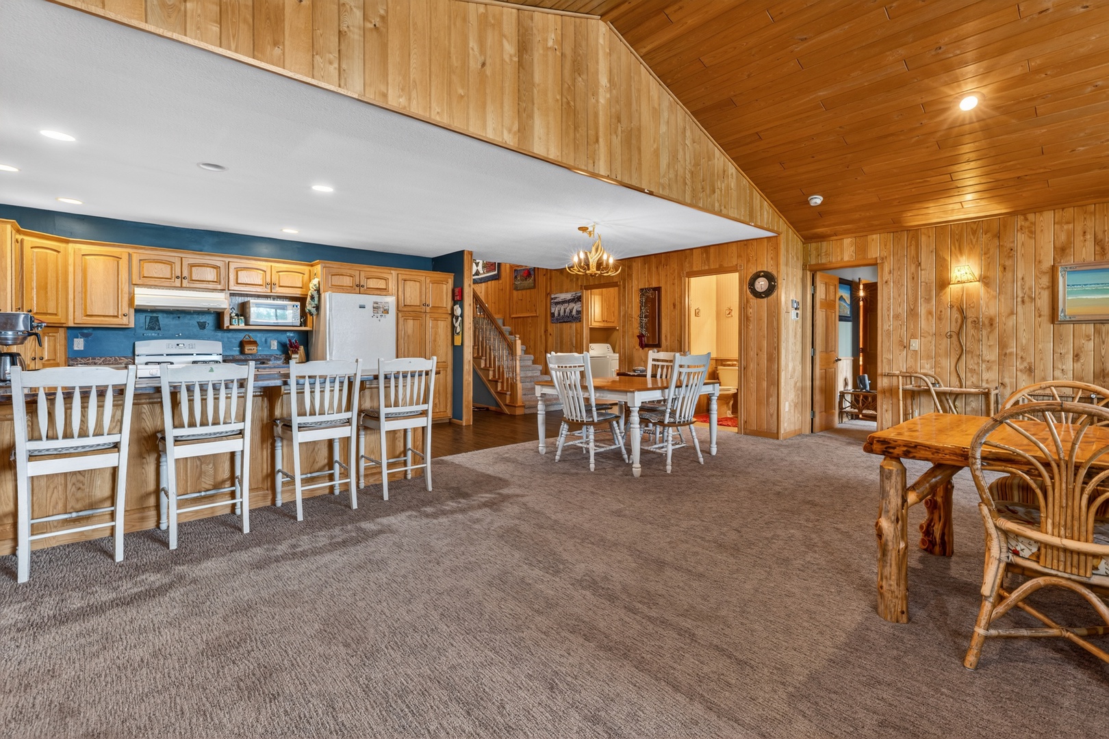 Gather around the spacious kitchen and dining areas, where warm wood tones and multiple seating options create the perfect setting for your group meals and memorable conversations together.