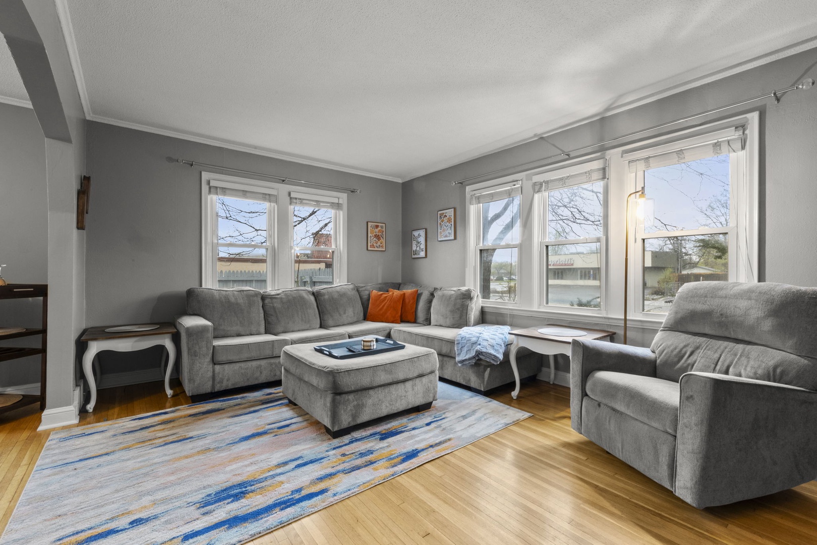 Unwind in your sunlit living room, where plush seating and large windows make for perfect cozy mornings or relaxing evenings after exploring.