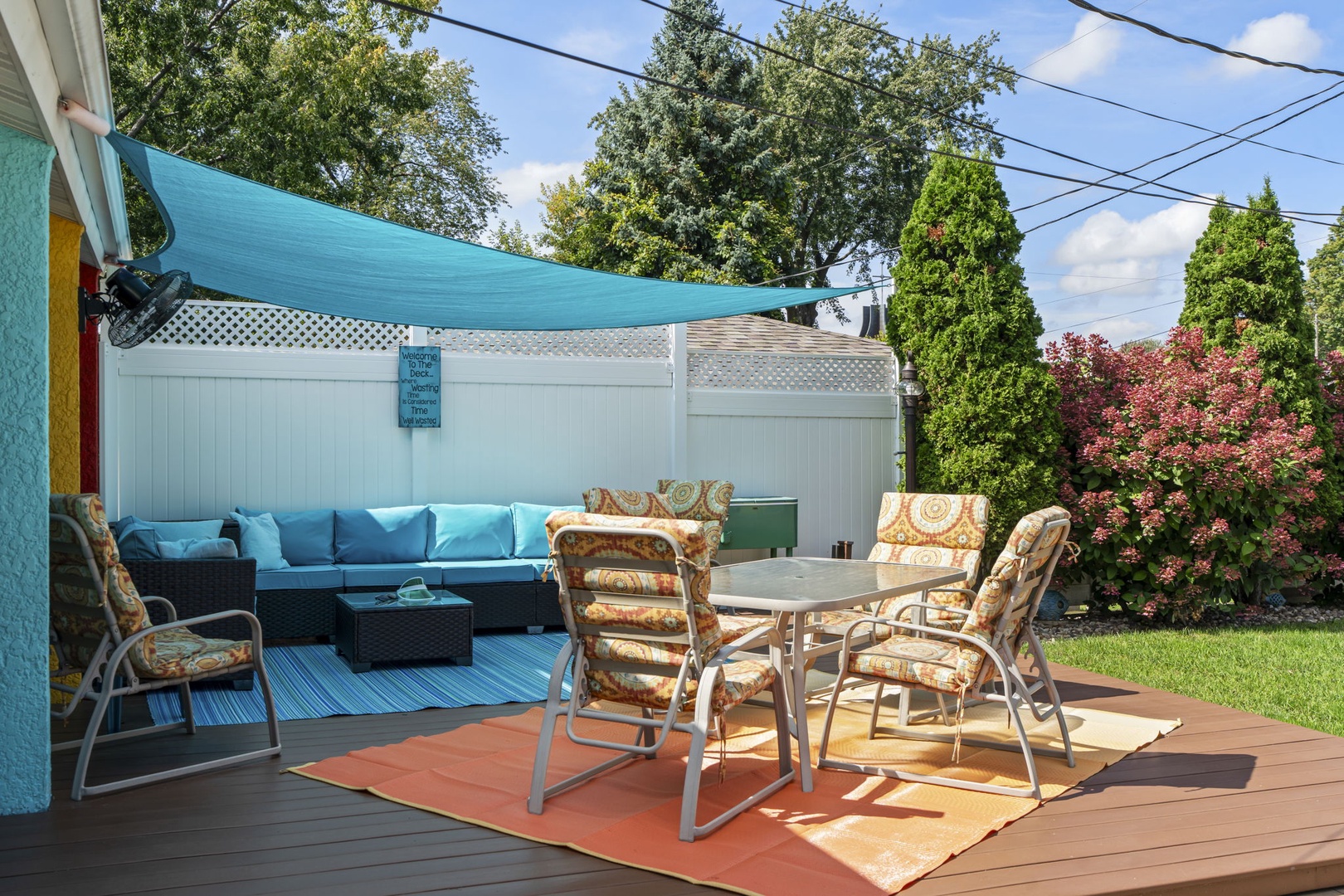 Relax in your private outdoor oasis featuring a shaded dining area and plush lounge seating, perfect for morning coffee or evening gatherings.