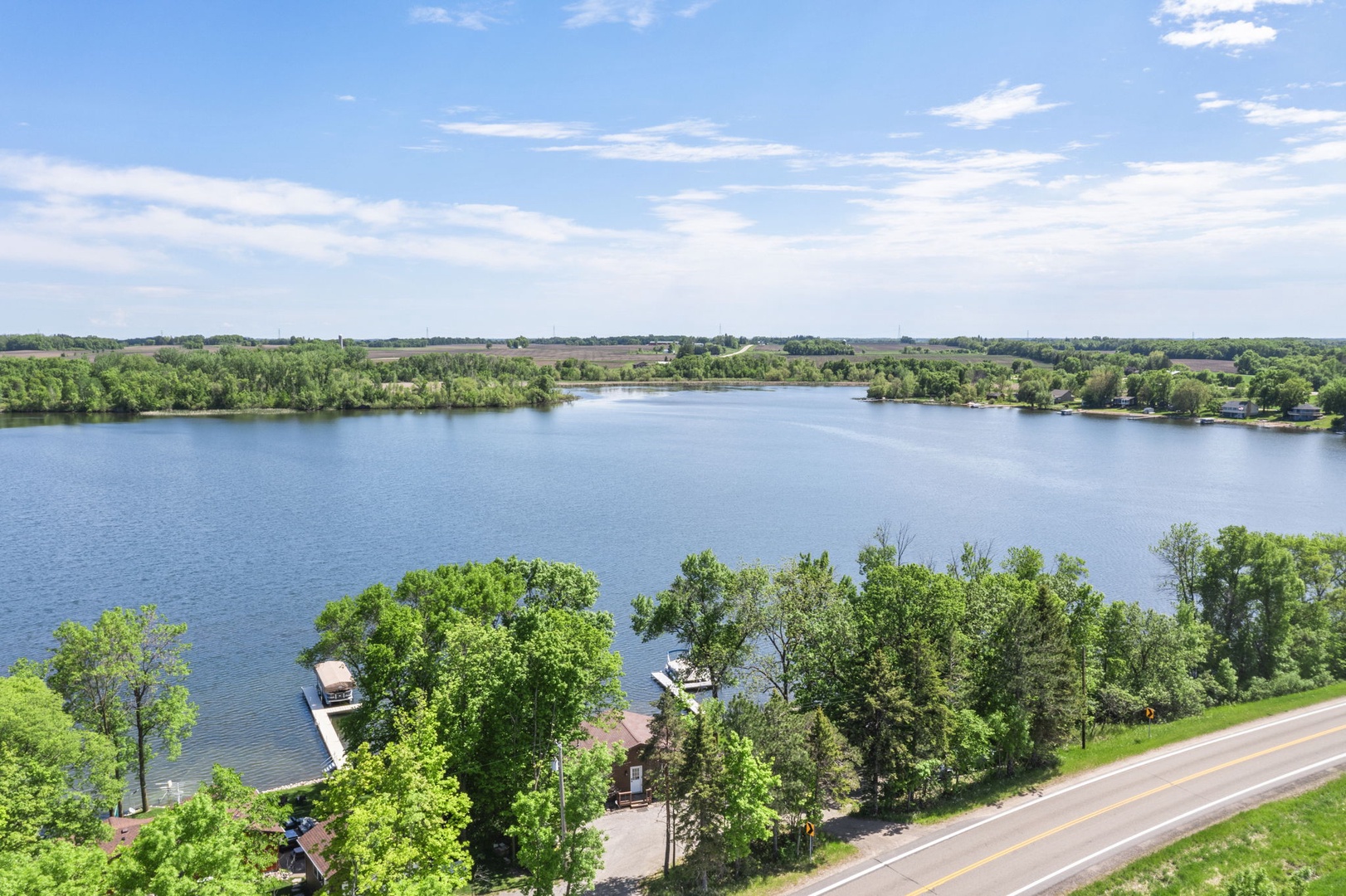 Scenic lakefront property surrounded by lush greenery and tranquil waters, offering a peaceful natural setting near abundant outdoor recreation opportunities.