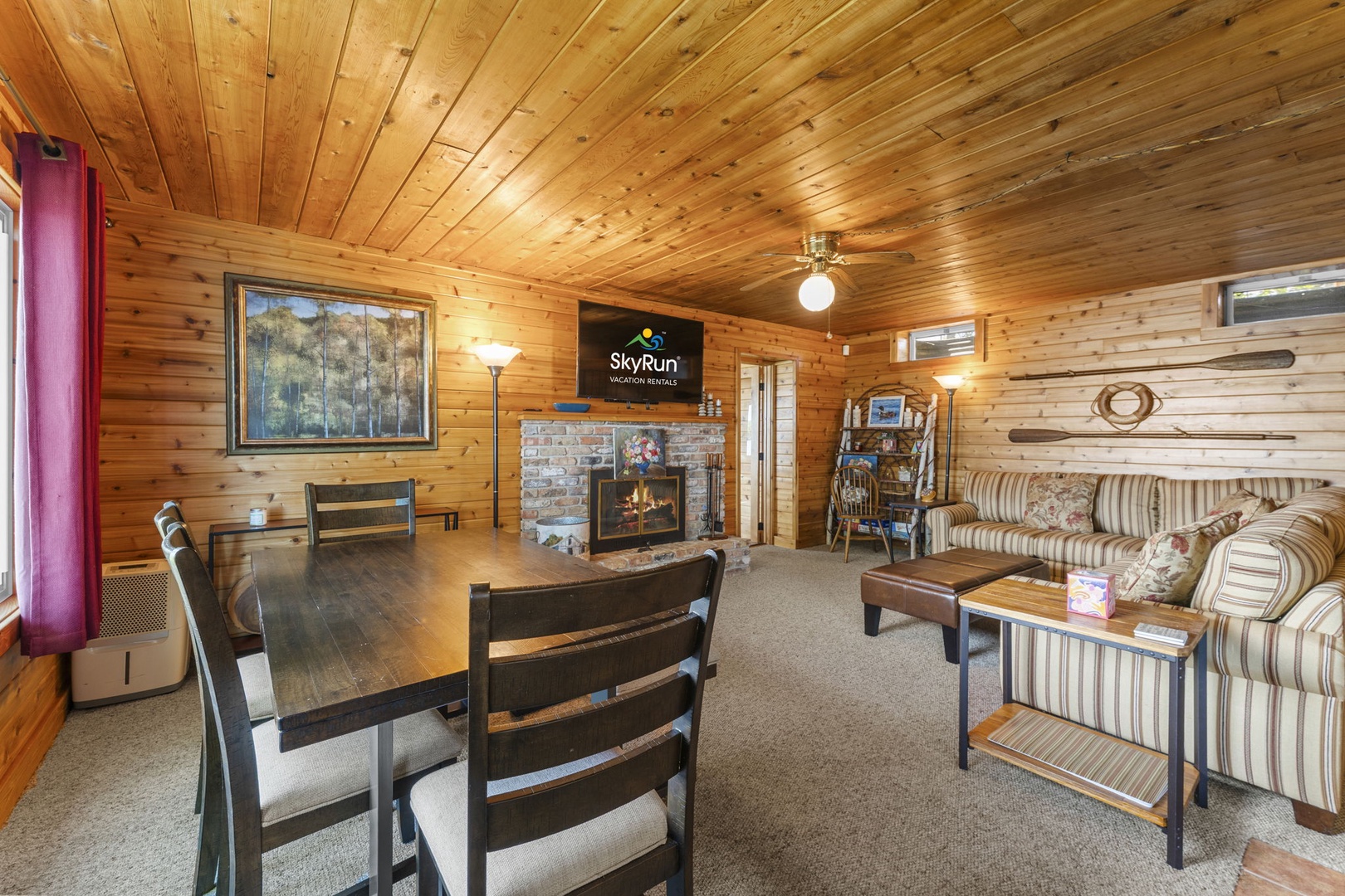 Relax in your cozy mountain retreat with soaring knotty pine ceilings, a crackling stone fireplace, and comfortable furnishings inviting you to unwind after exploring.