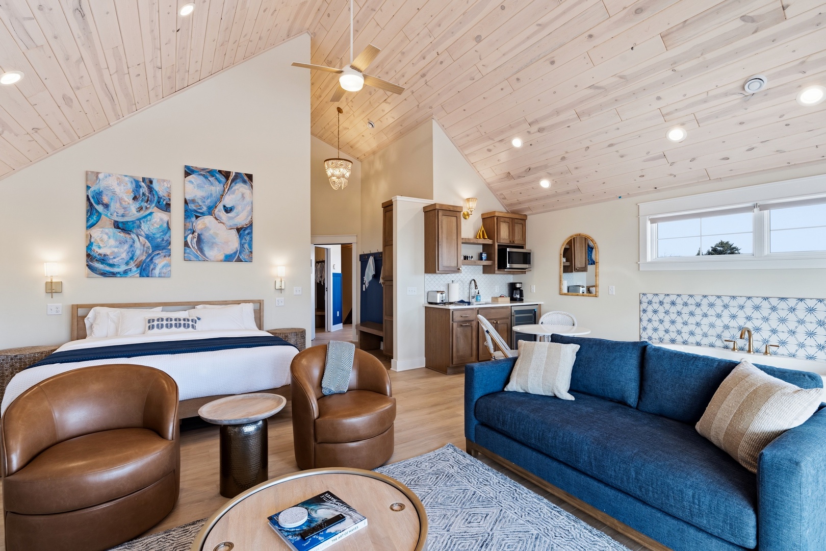 Open studio with king bed kitchenette and coastal artwork