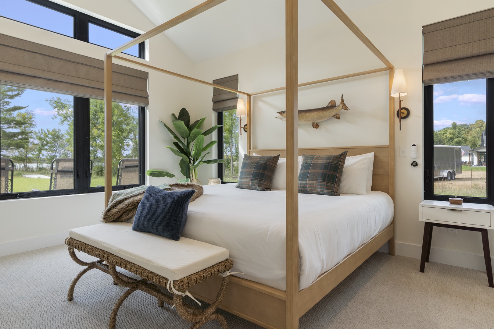 Sink into crisp linens in your elegant four-poster bed, where rustic charm meets refined comfort in a light-filled retreat with serene pastoral views.