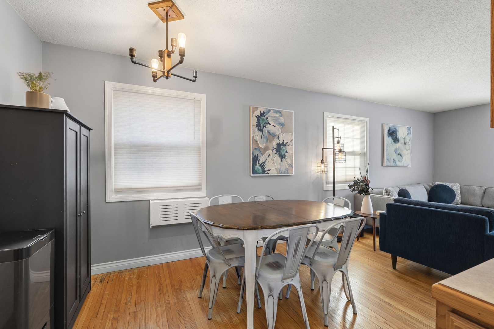 Gather around your dining table for memorable meals in this thoughtfully designed space with warm lighting and comfortable seating.