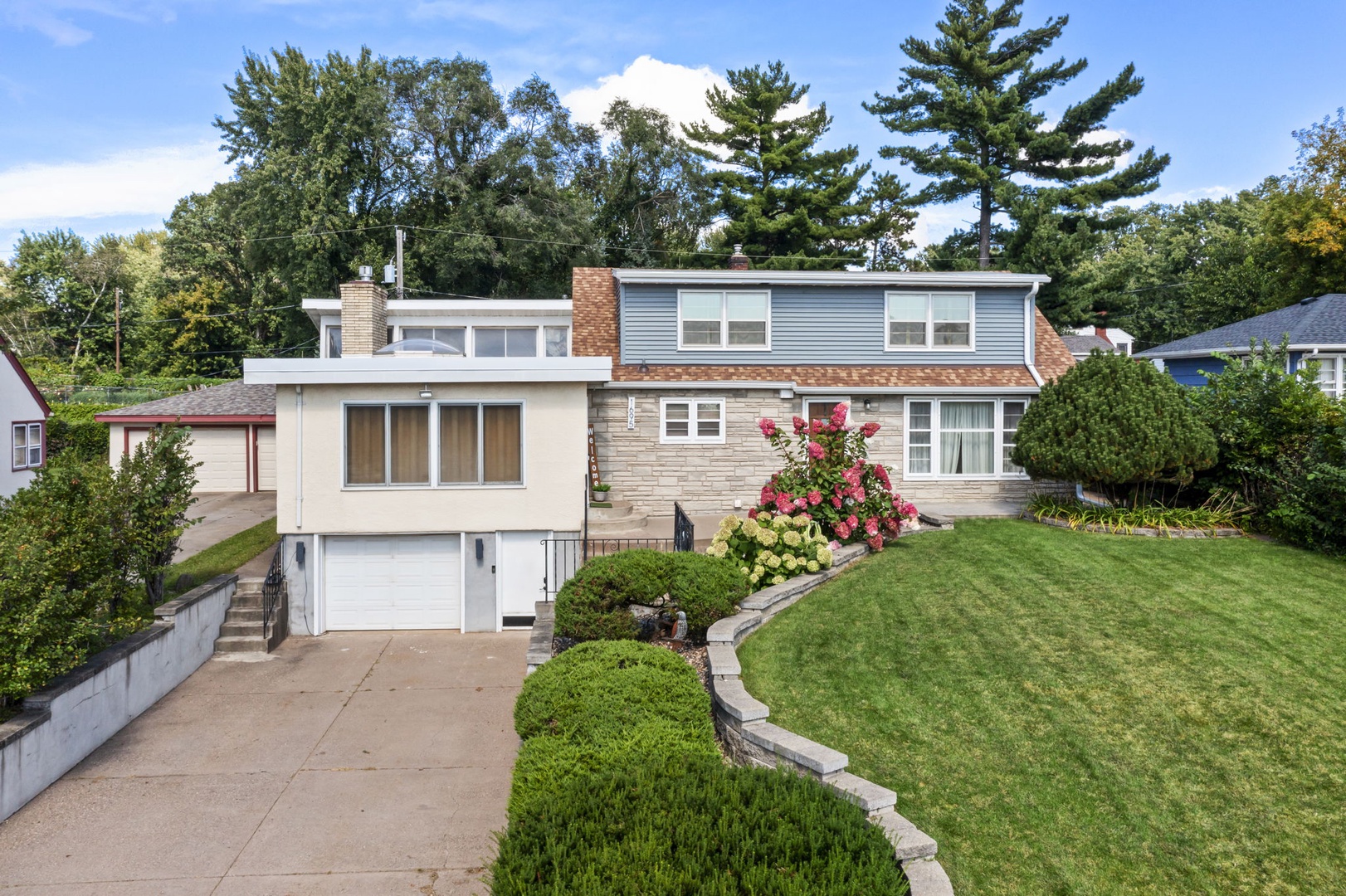 Charming residential property featuring beautifully landscaped grounds with mature trees and flowering gardens in a peaceful neighborhood setting.