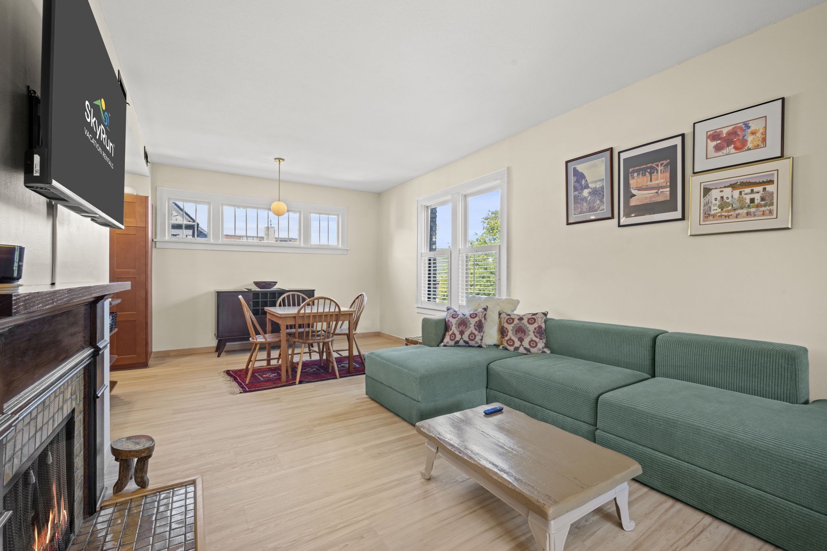 Sink into your cozy sectional and enjoy natural light from multiple windows while the dining area beckons just steps away—a perfect blend of relaxation and togetherness.