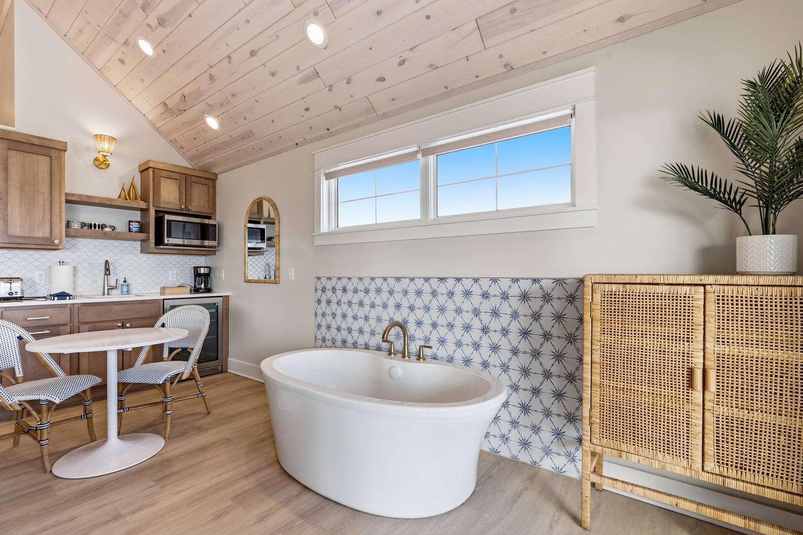 Your retreat features a freestanding soaking tub with gorgeous tilework, vaulted wood ceilings, and a cozy kitchenette for morning coffee. A bright, airy space where comfort meets style.
