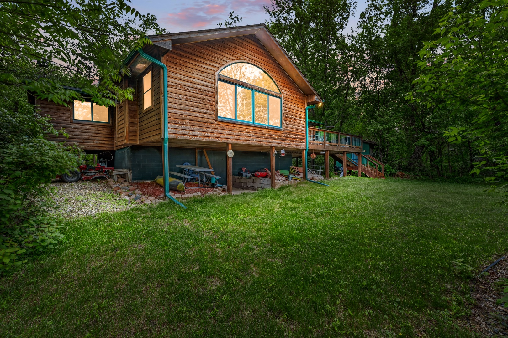 Warm cedar cabin nestled among tall trees offers a peaceful woodland retreat with spacious outdoor areas and charming architectural details.