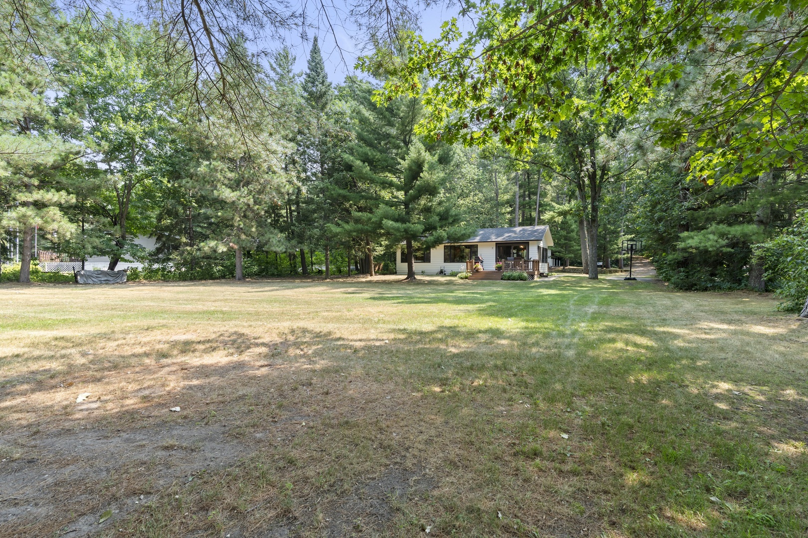 Nestled among towering pines and mature hardwoods, this cozy retreat offers peaceful seclusion in a lush natural setting. The spacious wooded grounds create a tranquil backdrop for your getaway.