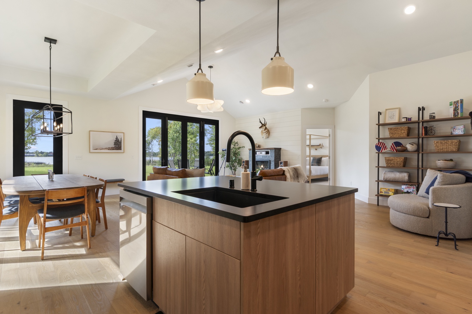 Sunlight streams through tall windows, illuminating your open-concept space where cooking, dining, and relaxing flow together seamlessly—perfect for gathering and unwinding.