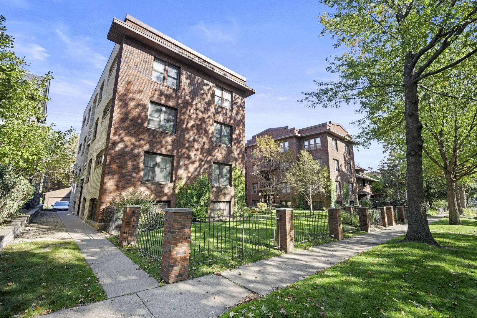 This brick property sits in a tree-lined neighborhood with manicured green lawns and peaceful surroundings, offering a quiet residential setting for your stay.