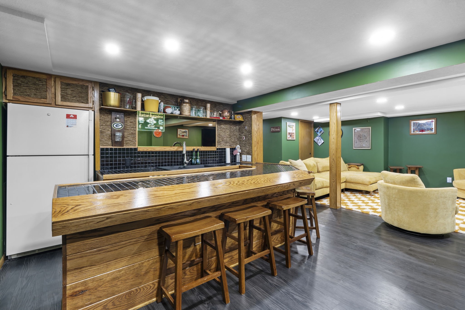 You'll love gathering in this spacious basement retreat with its full bar, cozy seating area, and warm wood accents.
