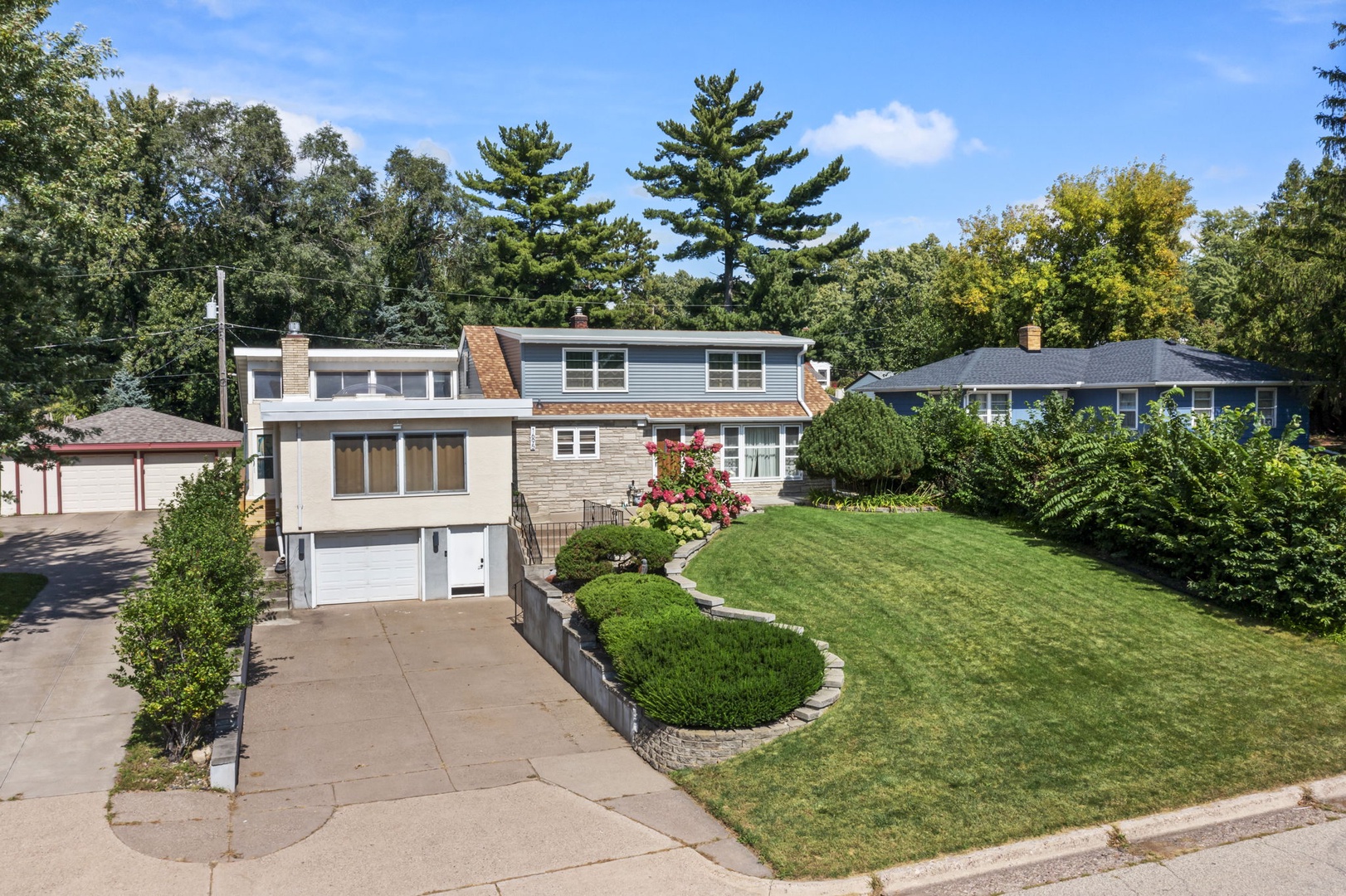 A charming property nestled in a quiet residential neighborhood with mature trees and landscaped gardens surrounding the home.