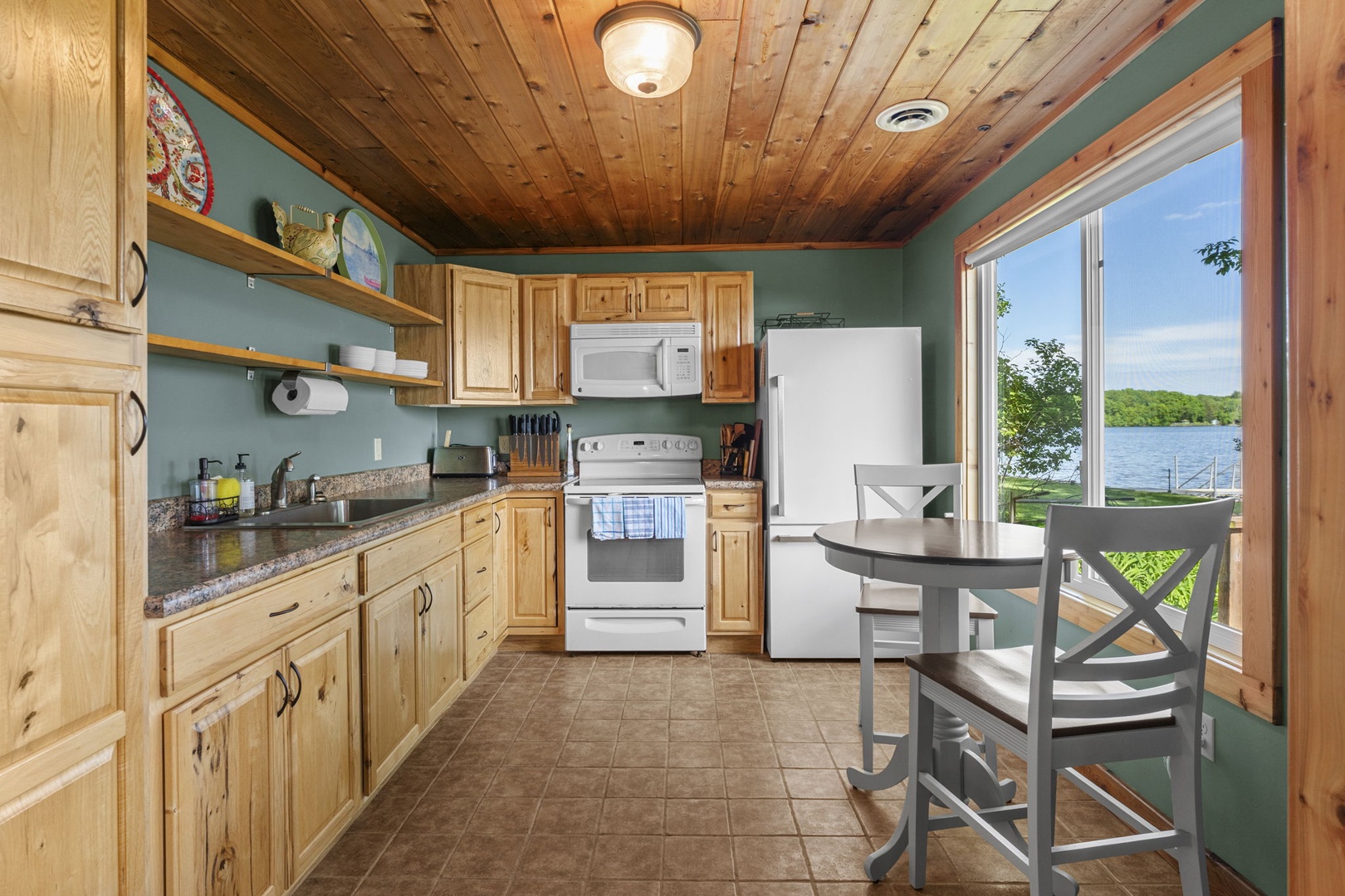 You'll love preparing meals in this bright kitchen with stunning lake views just outside your door. Warm wood details and modern appliances make cooking a pleasure.