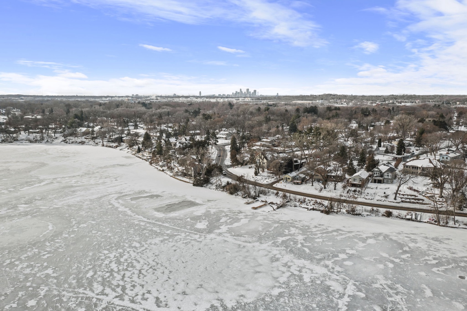 Panoramic winter view with Minneapolis skyline visible in the distance