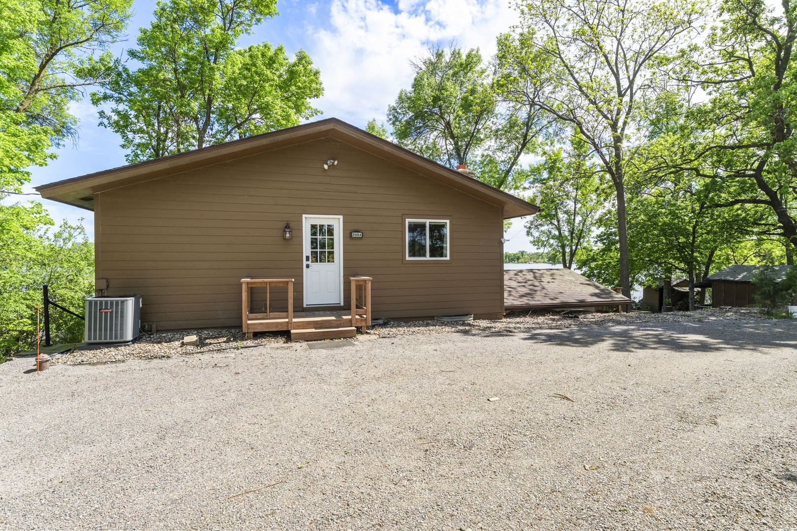 Nestled in lush greenery, this inviting cabin offers a peaceful wooded retreat with ample parking and a private outdoor escape just steps from your door.