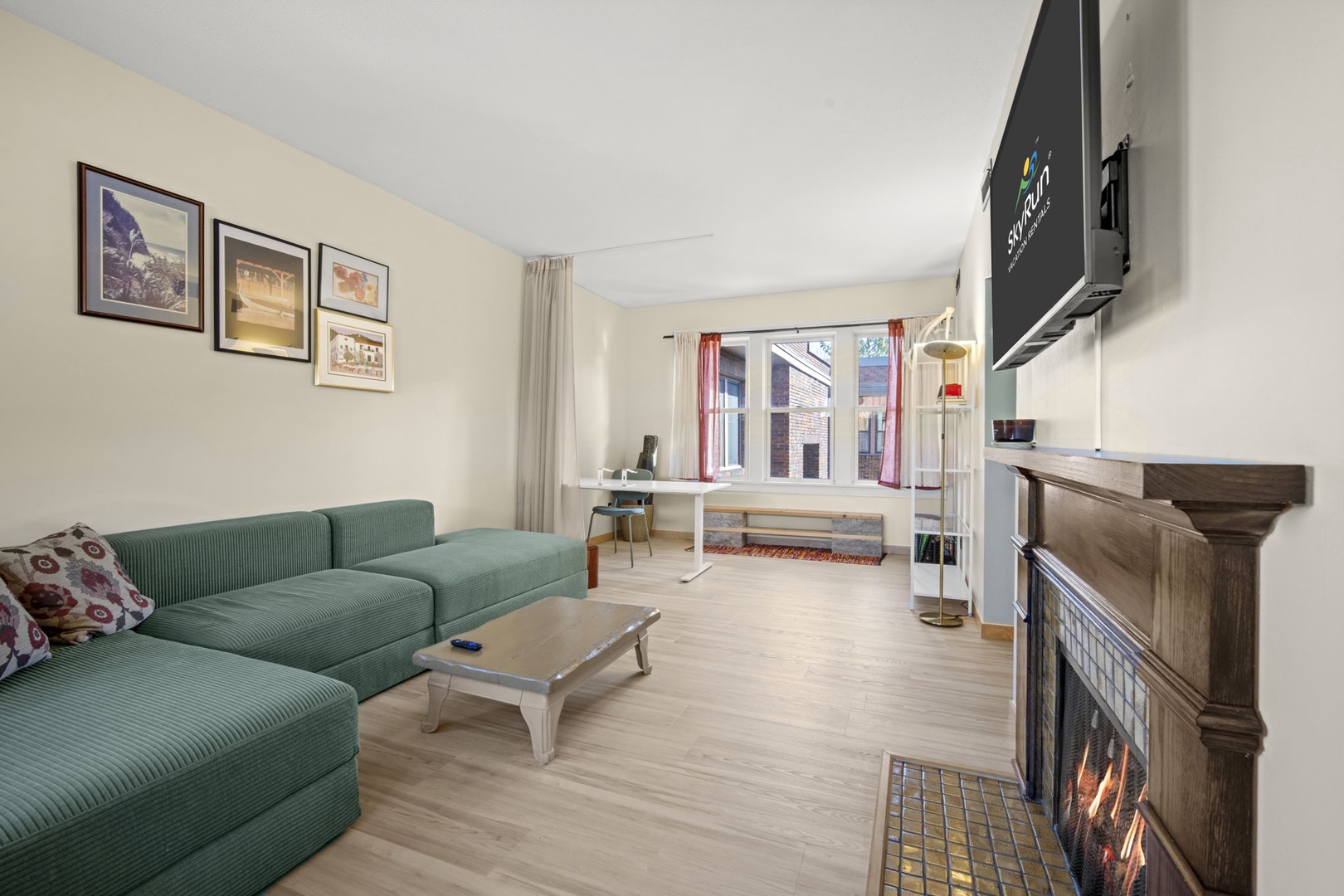 Relax on the cozy sofa or gather around the dining table in this bright, open living space. The warm fireplace and natural light create a welcoming atmosphere perfect for unwinding after your adventures.