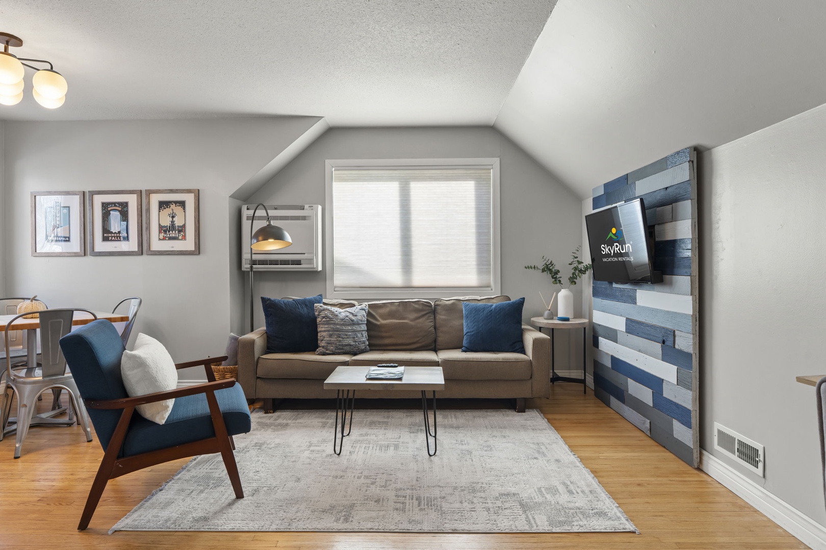 Relax in this stylish living room with cozy seating, modern TV, and charming touches that make you feel instantly at home.