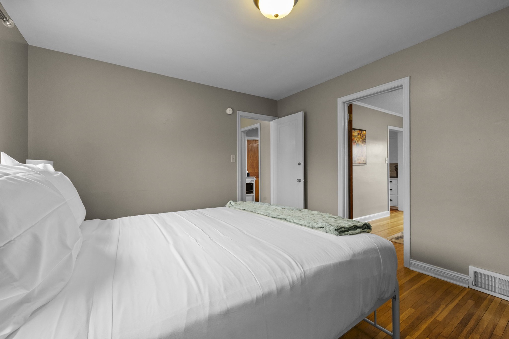 Sink into soft bedding and unwind in your peaceful retreat. Warm tones and gleaming floors create a serene escape where rest comes easy after a day of adventure.