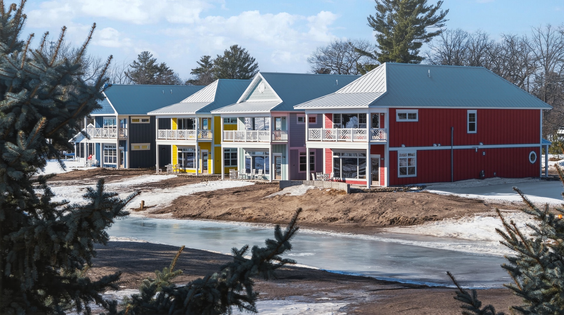 Colorful lakefront cottage community with covered porches and balconies