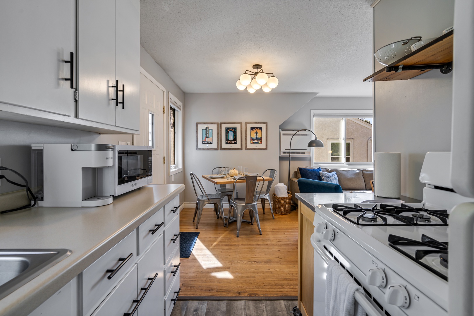 Your bright, modern kitchen opens to a cozy dining and living space, perfect for preparing meals and relaxing together.