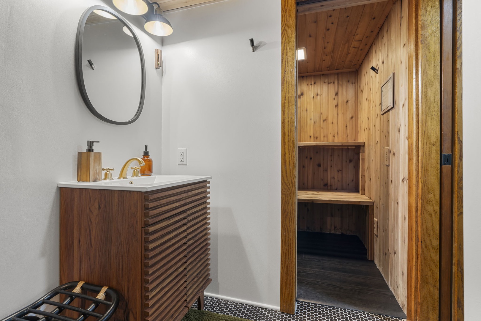 Unwind in your private sauna after enjoying the stylish vanity area with modern fixtures and warm wood tones.