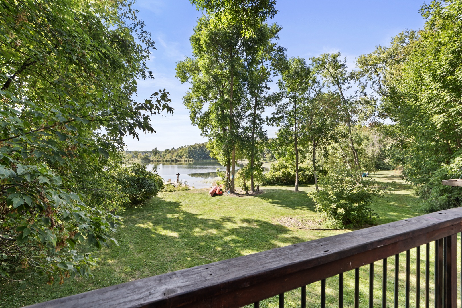 Step onto your private deck and take in the tranquil lake view, framed by lush trees and open lawn—perfect for morning coffee or unwinding after a day of exploring.