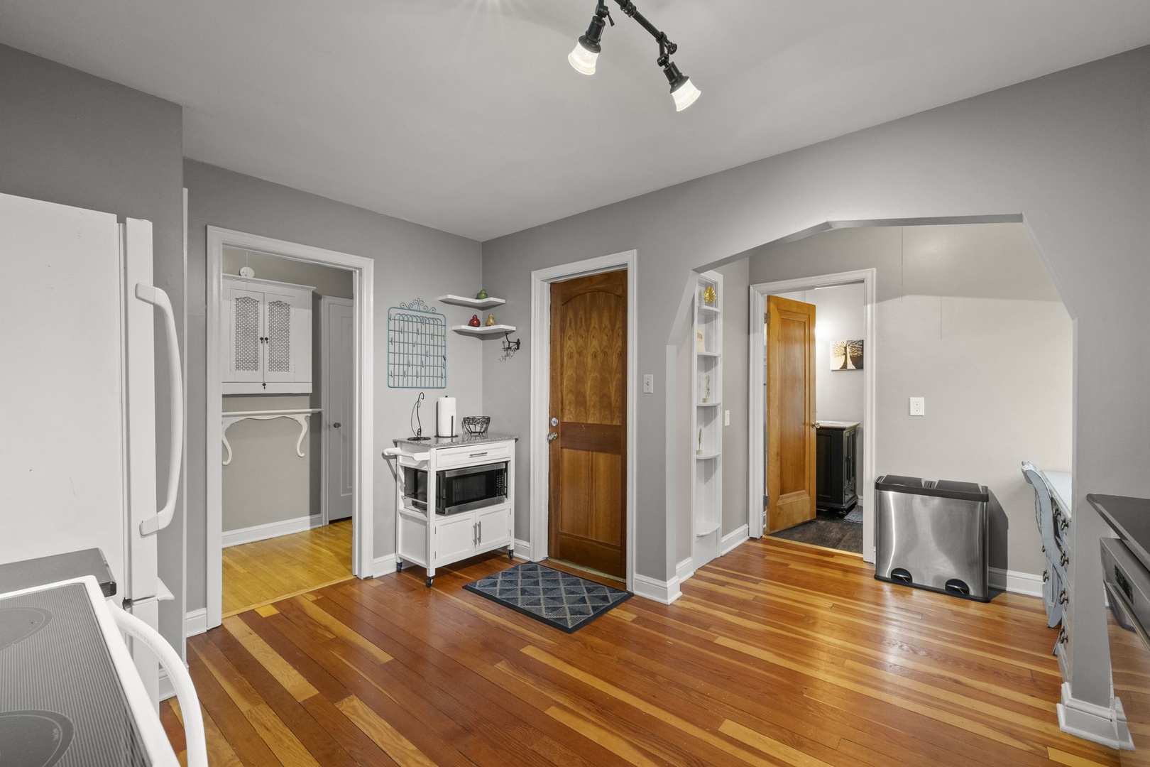 Step into this welcoming kitchen and dining space, where warm hardwood floors and bright natural light create an inviting atmosphere for your morning coffee or homemade meals.