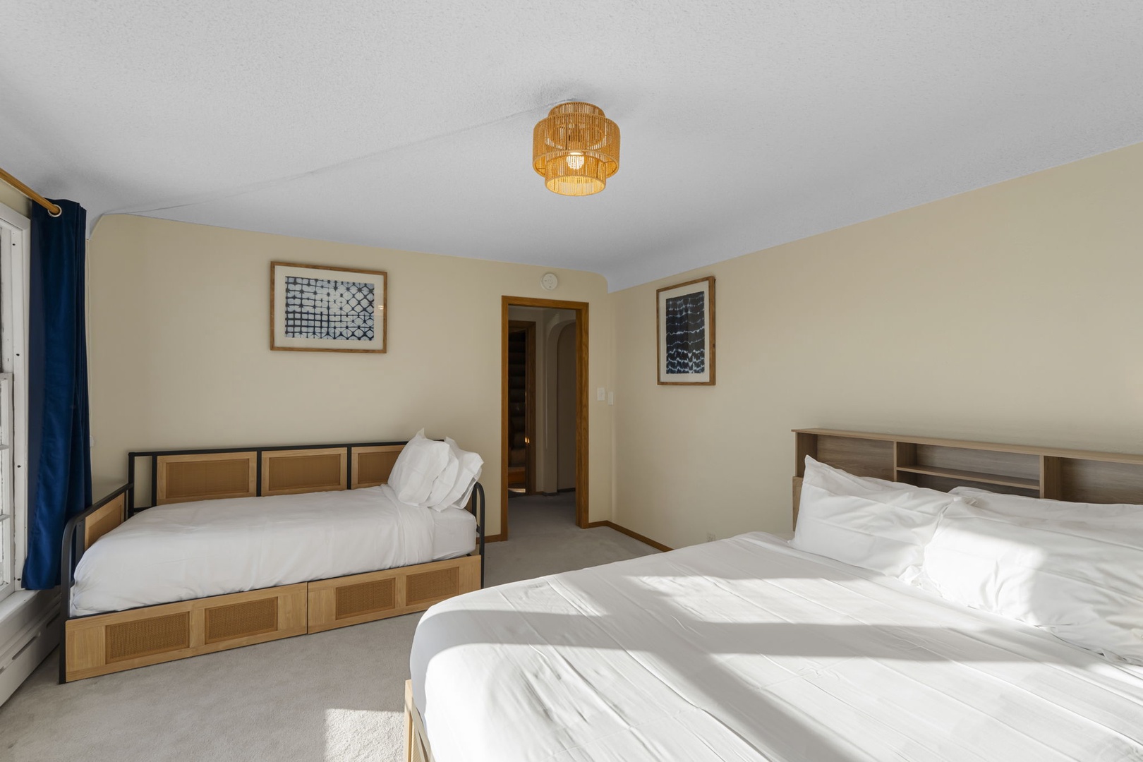 Main floor bedroom with queen bed and twin daybed