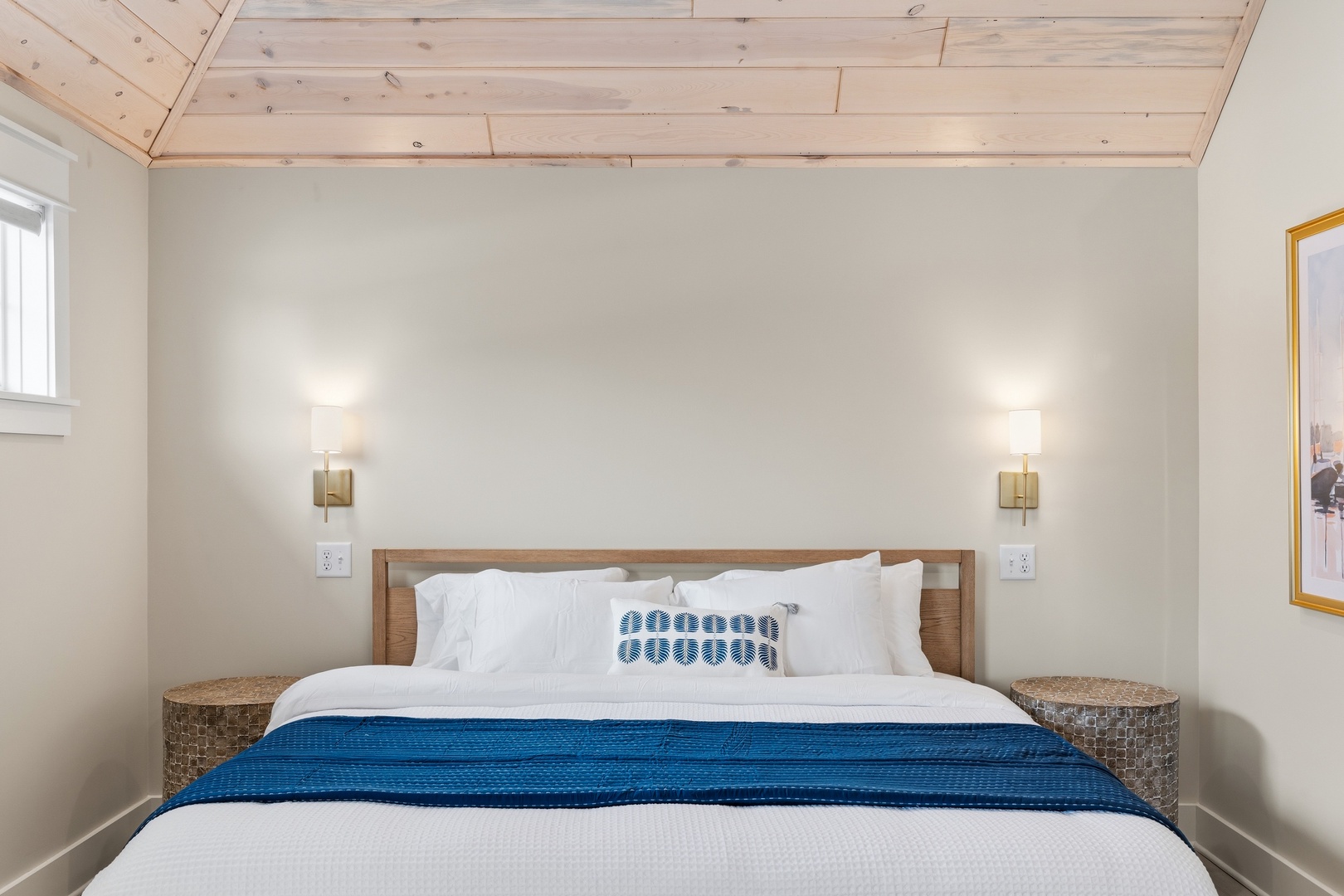 King bed with hotel-quality linens and warm wood ceiling