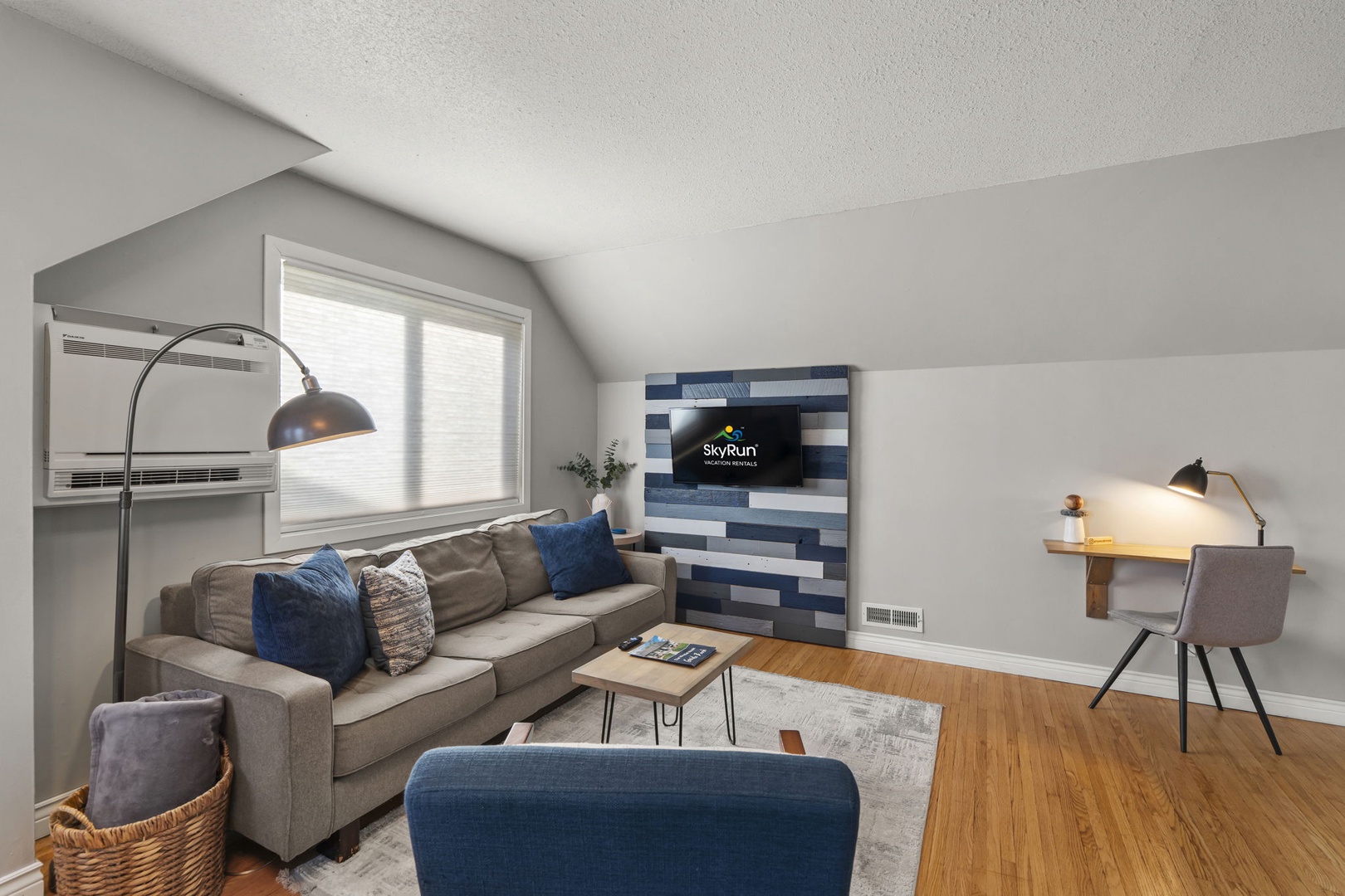 Settle into your stylish living space with comfortable seating and a dedicated workspace perfect for remote work or relaxation.