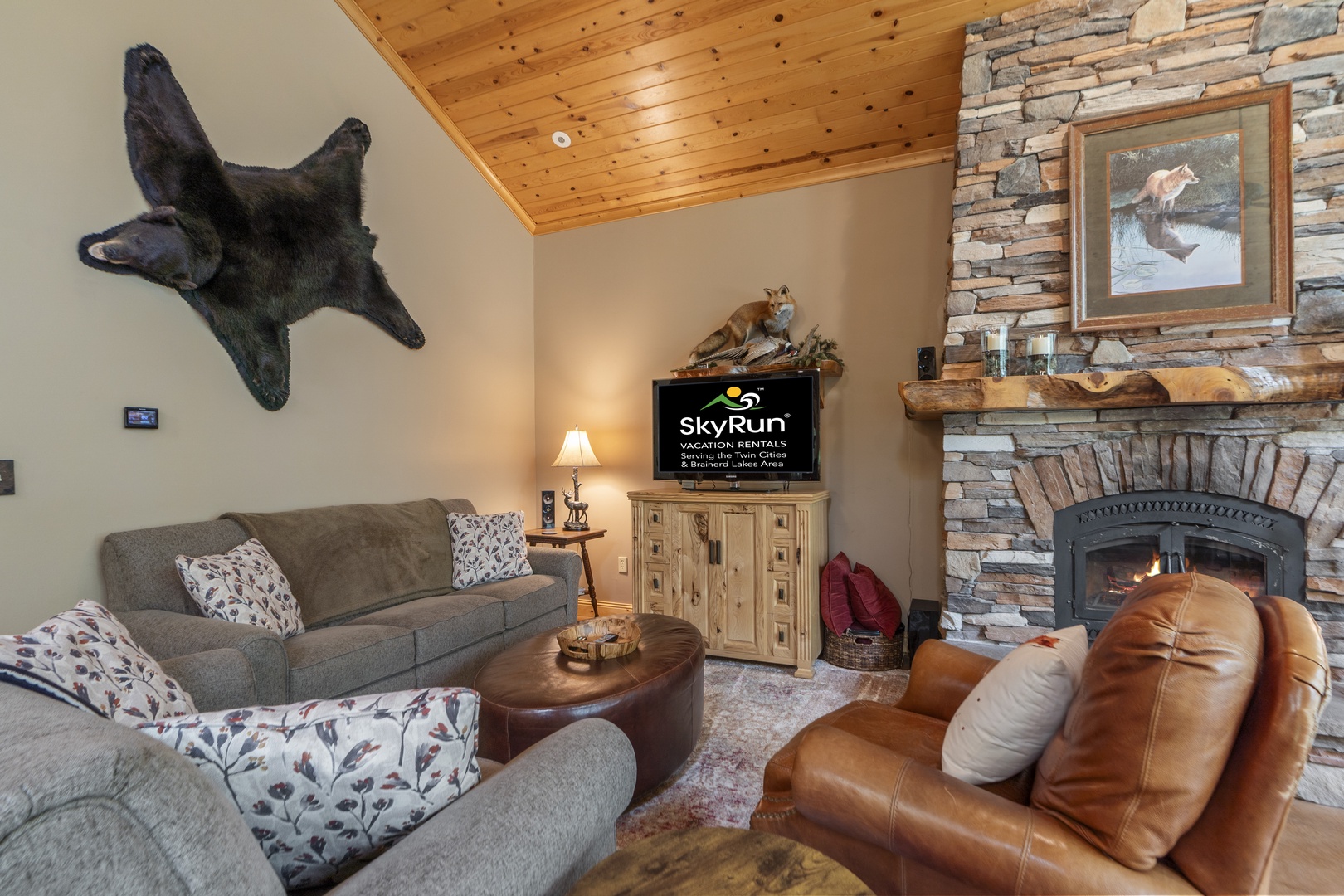 Sink into plush seating by your own stone fireplace, where rustic charm meets cozy comfort. The warm glow invites you to unwind after a day of adventure.