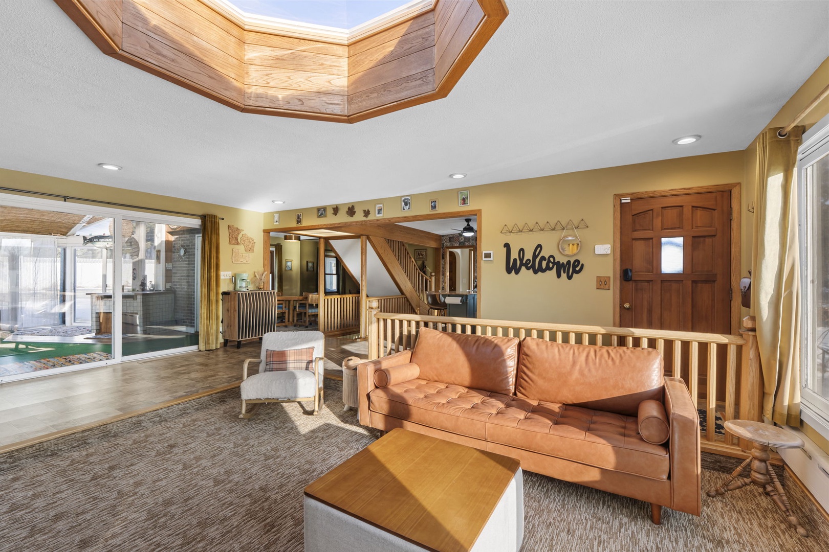 Unwind in your spacious living room, where warm leather seating and natural light from the skylights create the perfect retreat.