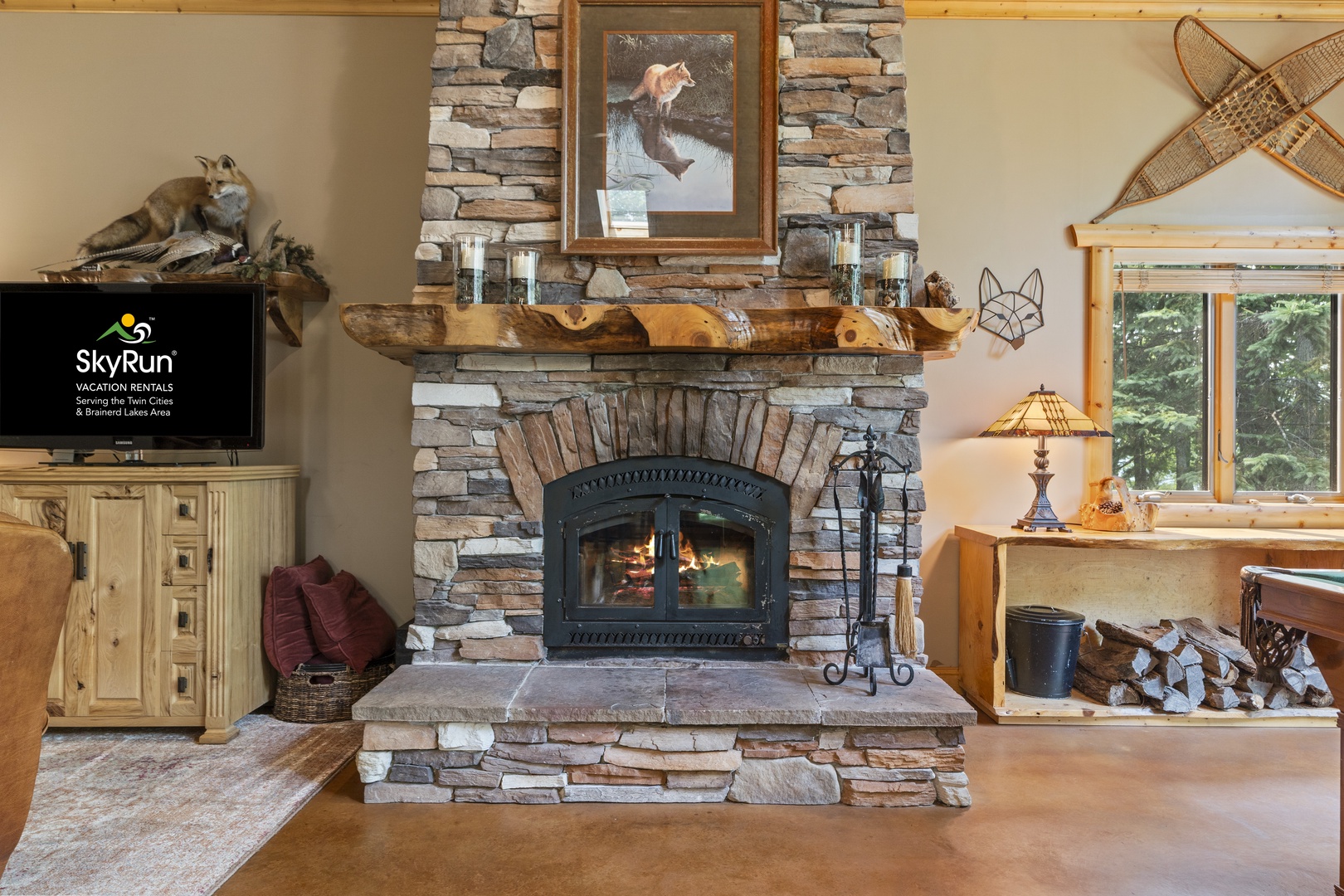 Gather by your crackling stone fireplace, where rustic charm meets cozy comfort. The woodsy decor and natural accents create a warm retreat perfect for unwinding after a day of adventure.
