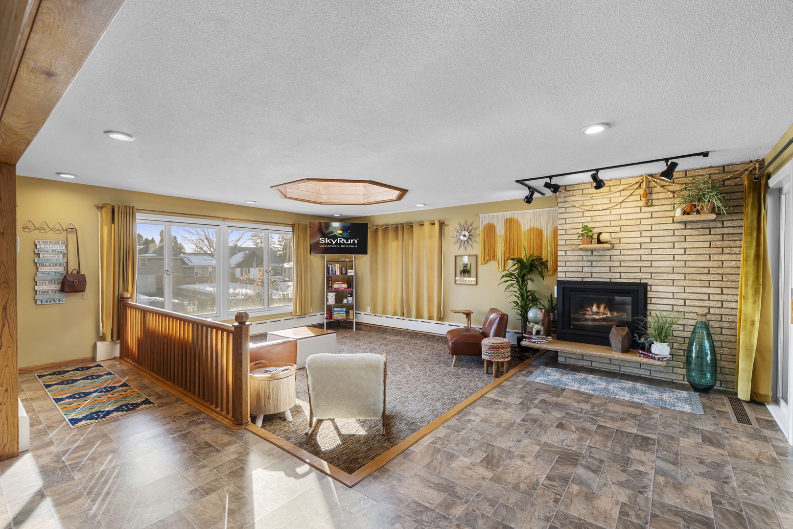 Relax in this inviting living area with cozy seating around a warm fireplace, perfect for unwinding after your adventures.