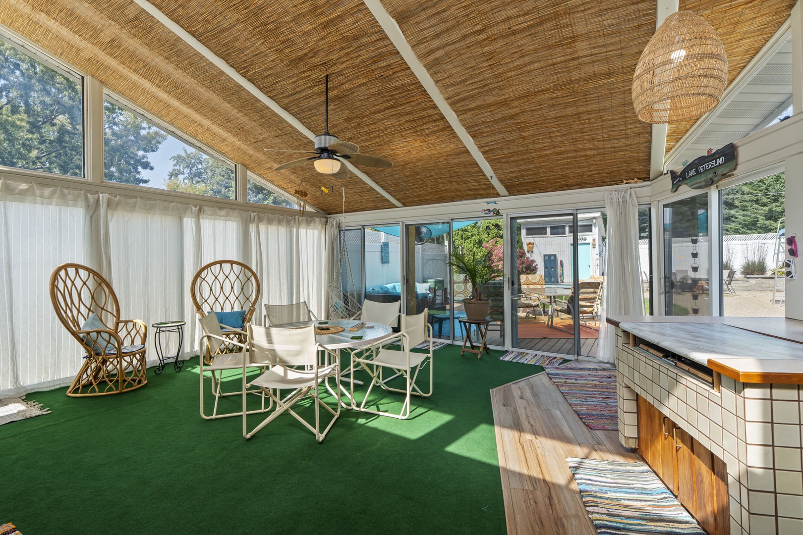 Relax in your private sunroom with wicker seating and bamboo ceiling. Sliding doors open to your outdoor space.
