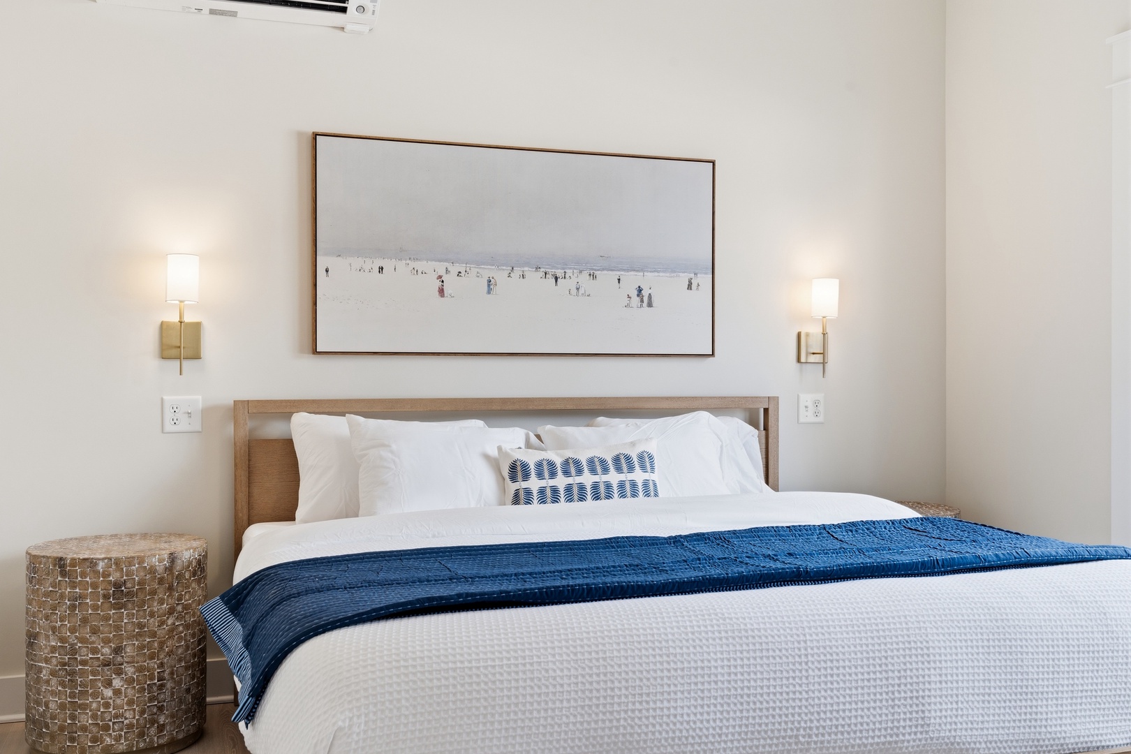 Serene king bedroom with luxury linens and beach art