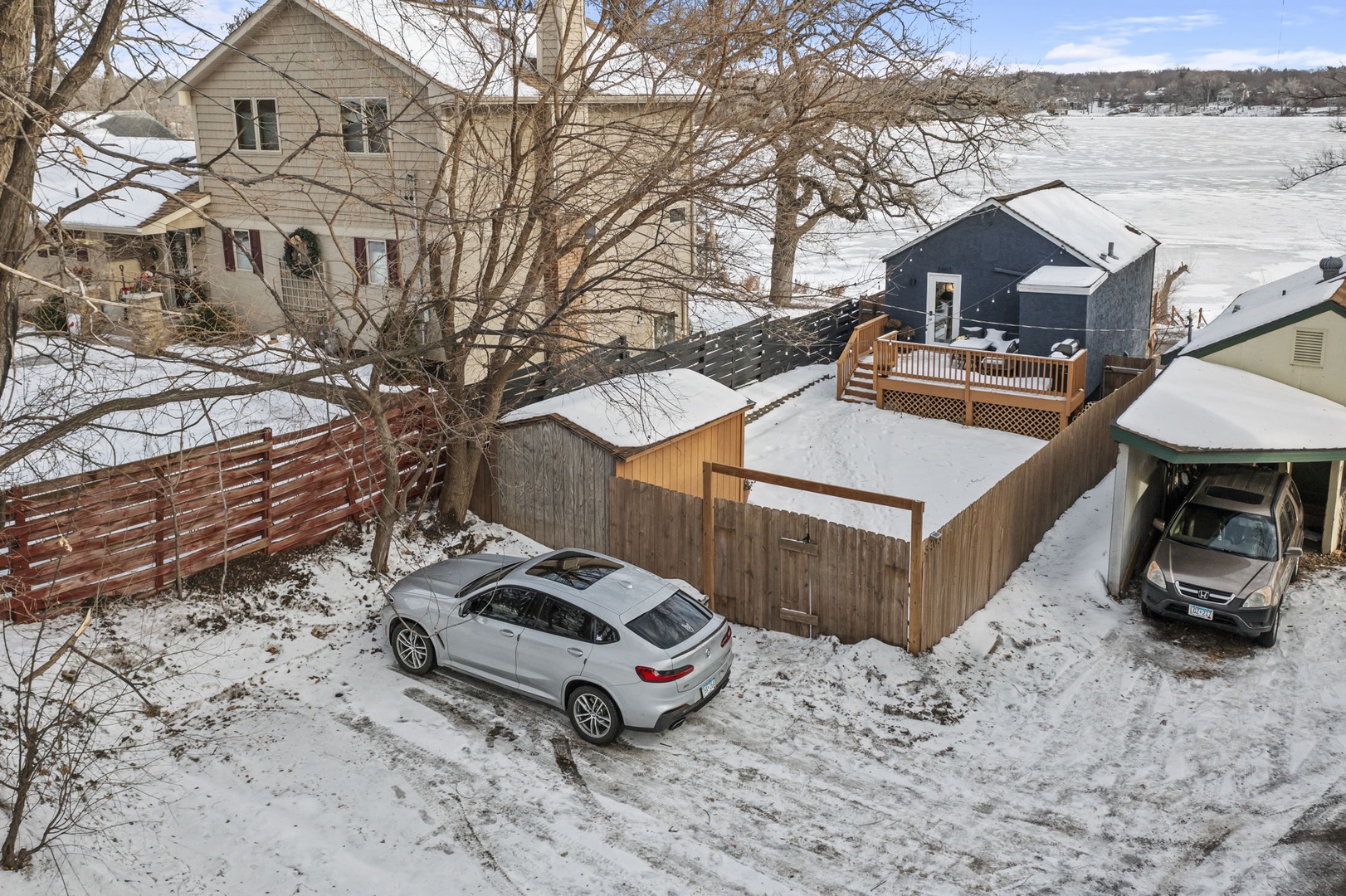 Charming lakeside property with convenient parking and scenic winter surroundings for your perfect getaway.