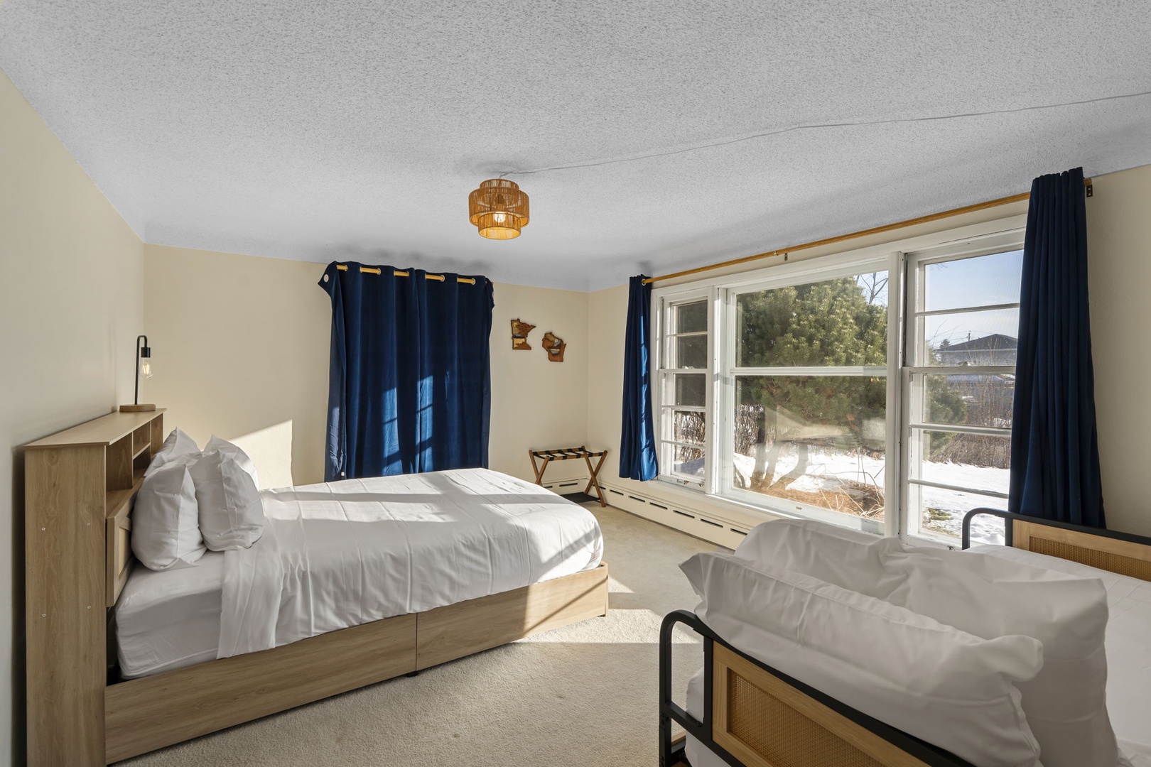 Spacious main floor bedroom with a queen bed and twin daybed.