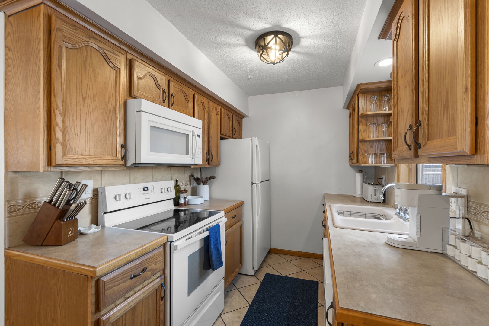Your fully equipped kitchen features warm oak cabinets, modern appliances, and ample counter space for preparing memorable meals.