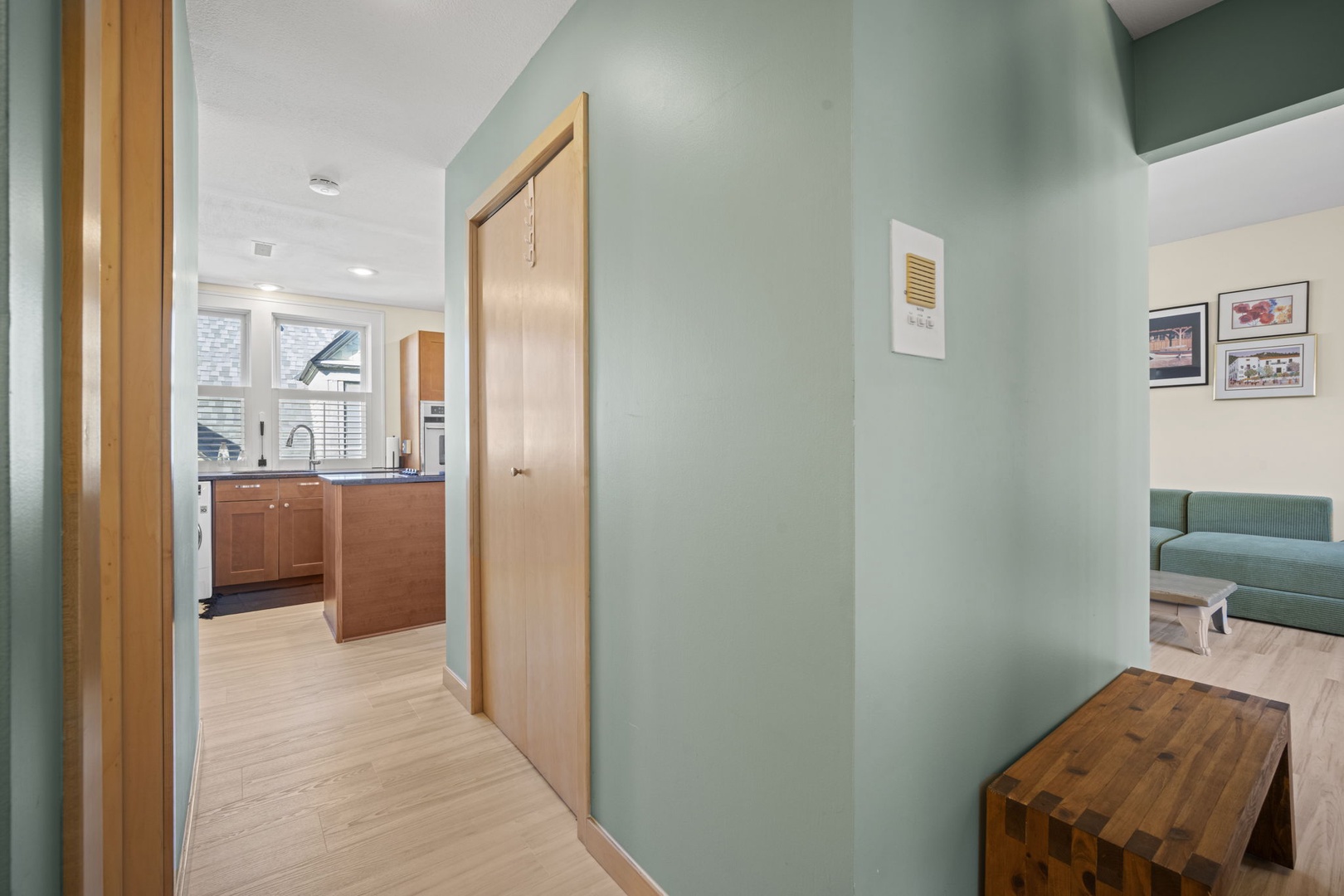Step into your bright, thoughtfully designed space where soft sage walls and warm wood accents create an instantly calming atmosphere. The open layout flows seamlessly from your well-equipped kitchen to cozy seating area.