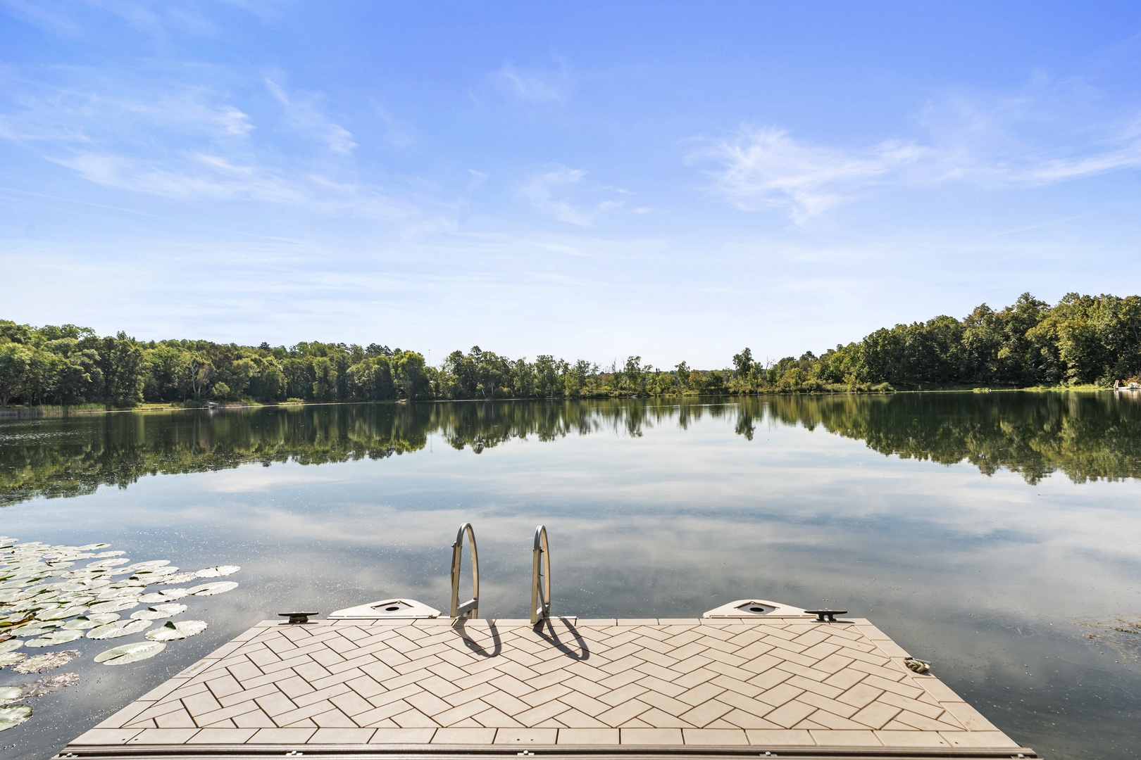 Private lake access from the property features a dedicated swimming dock with ladder and cleats for water recreation.