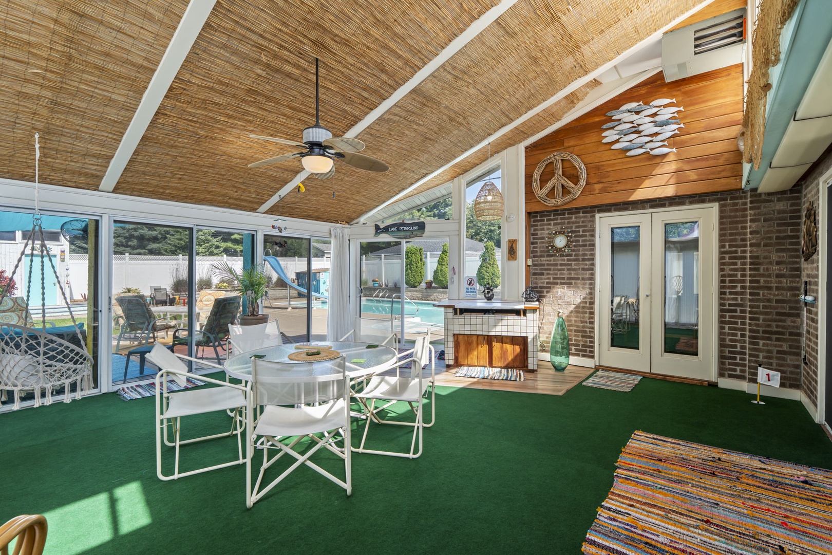 Your stylish covered patio blends indoor comfort with outdoor living, featuring bamboo ceilings and direct backyard access.
