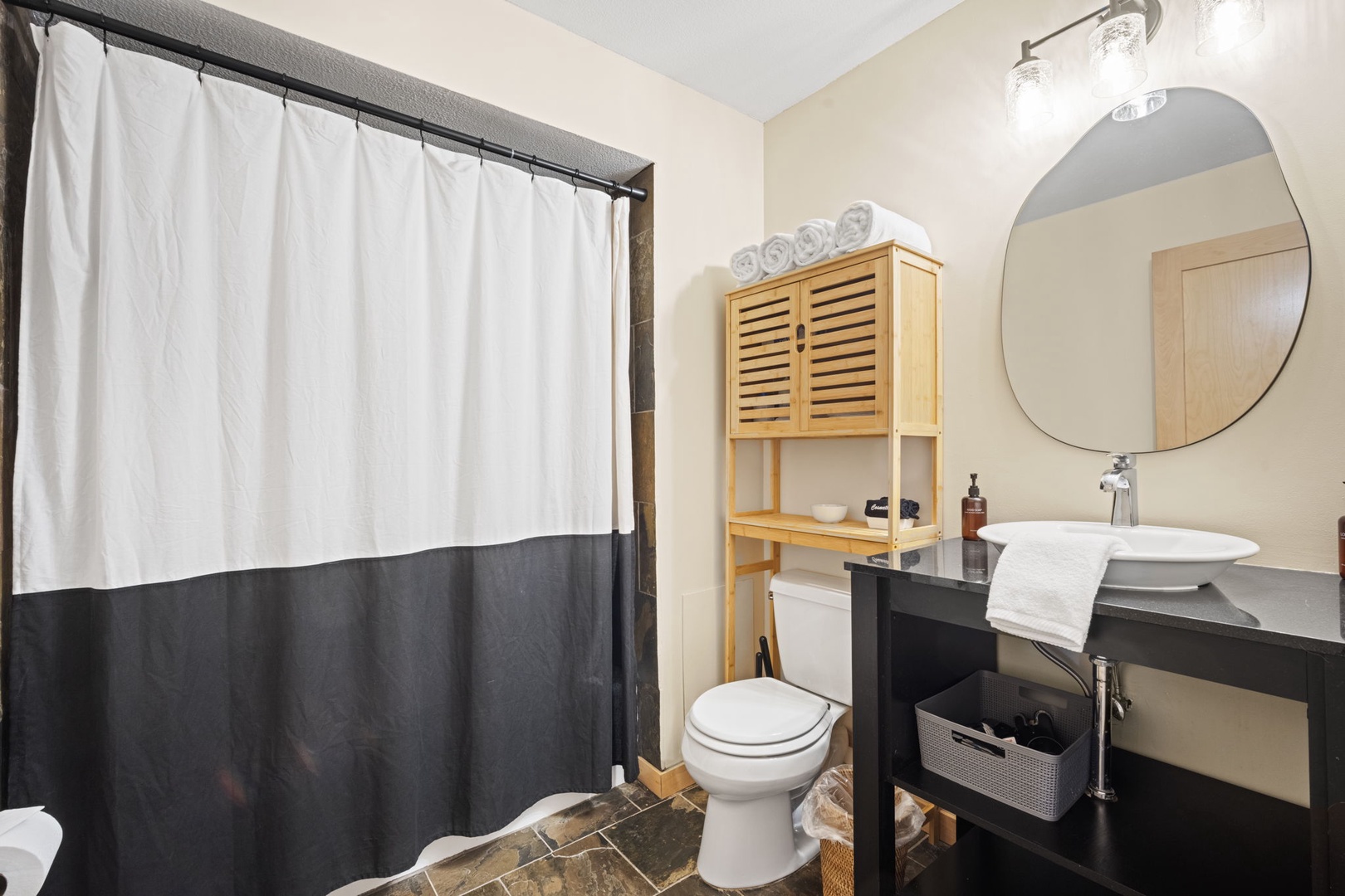 Your private bathroom offers clean lines and thoughtful touches, including fluffy towels and ample storage to help you settle in and refresh after a day exploring.